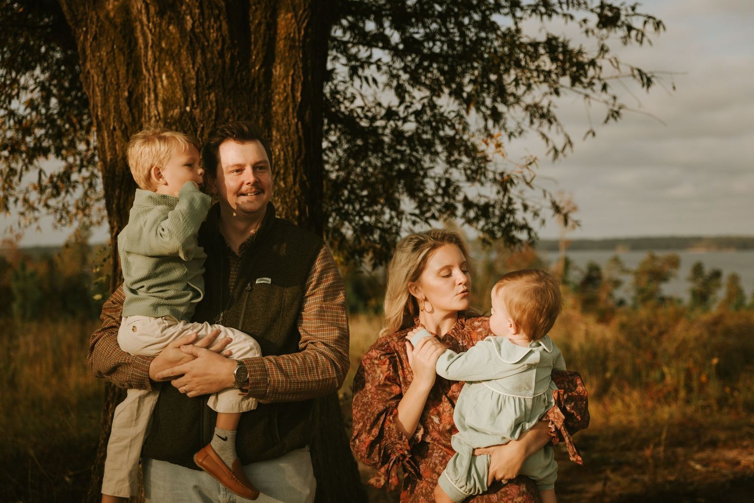 Family laughing together during an outdoor photo session in Evans Georgia at golden hour