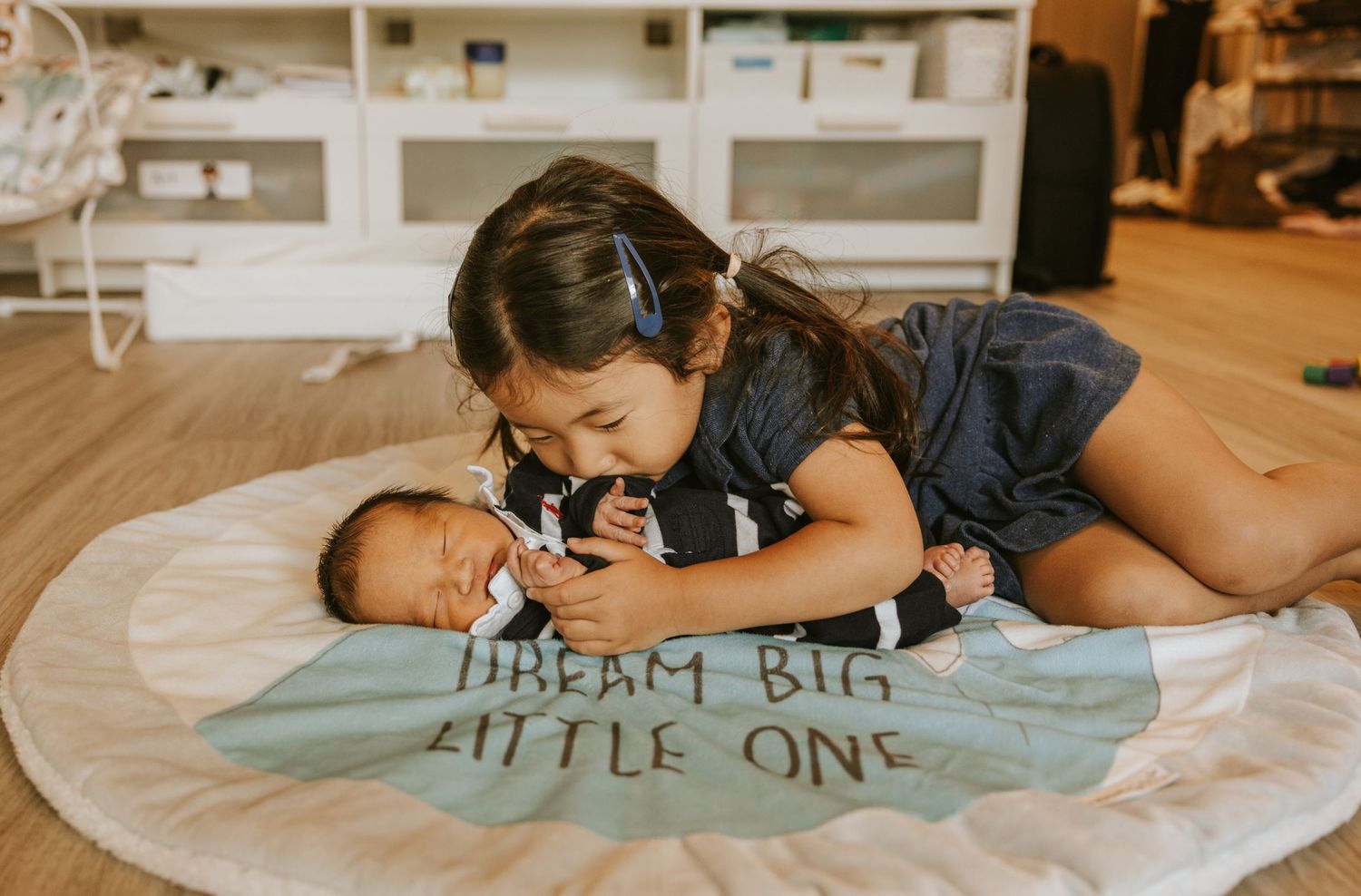 Lifestyle family photography capturing sister with baby brother in Evans GA
