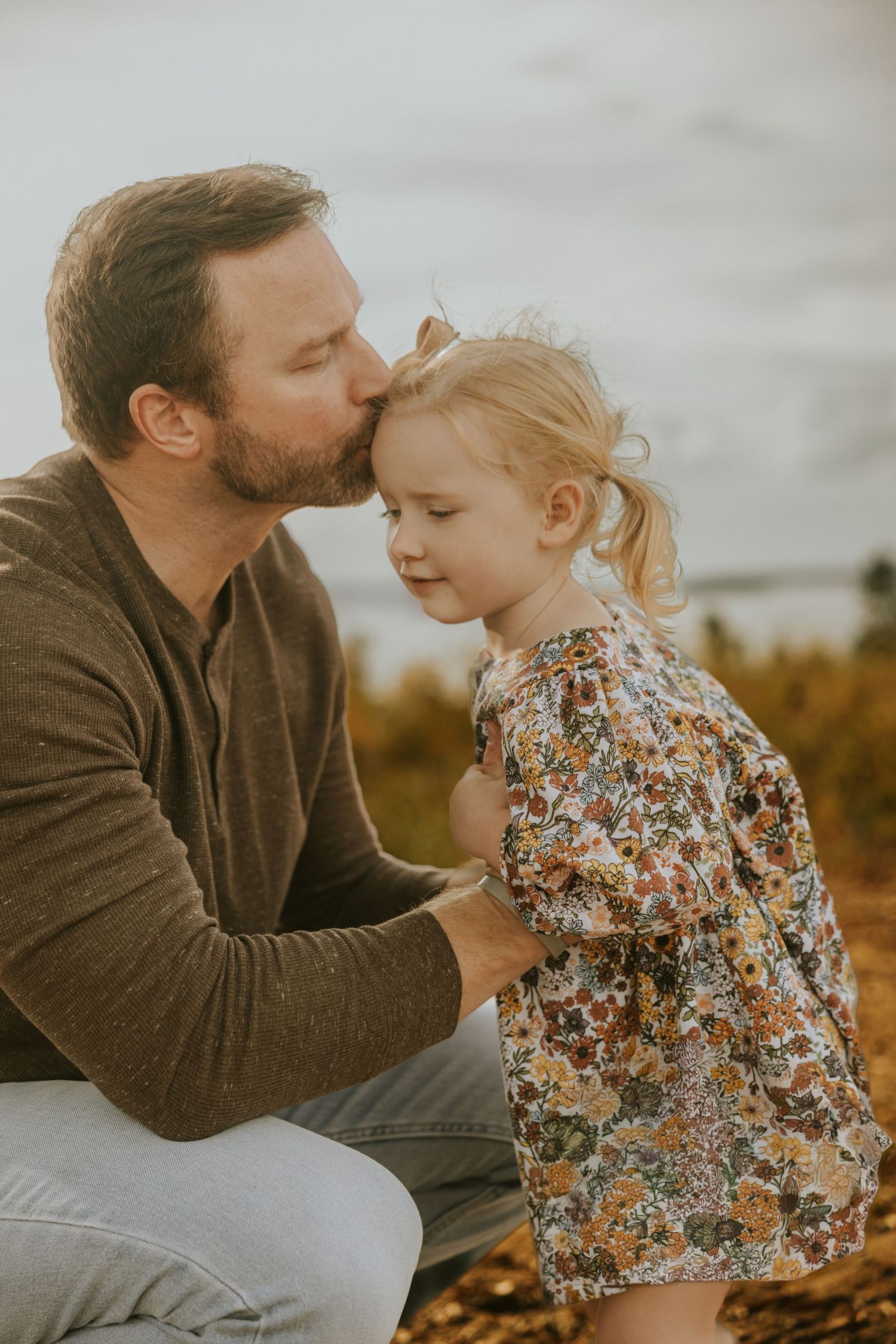 Father and daughter embracing outdoors during a Evans, the CSRA family photography session