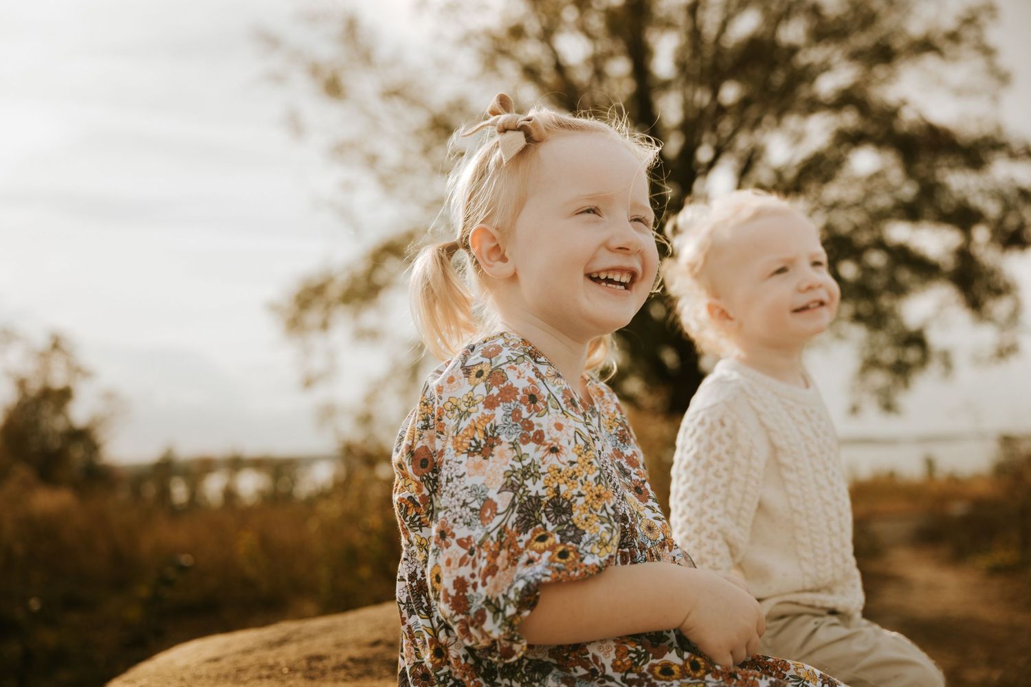 Tender sibling connection between a toddler brother and sister during a Evans family photo session