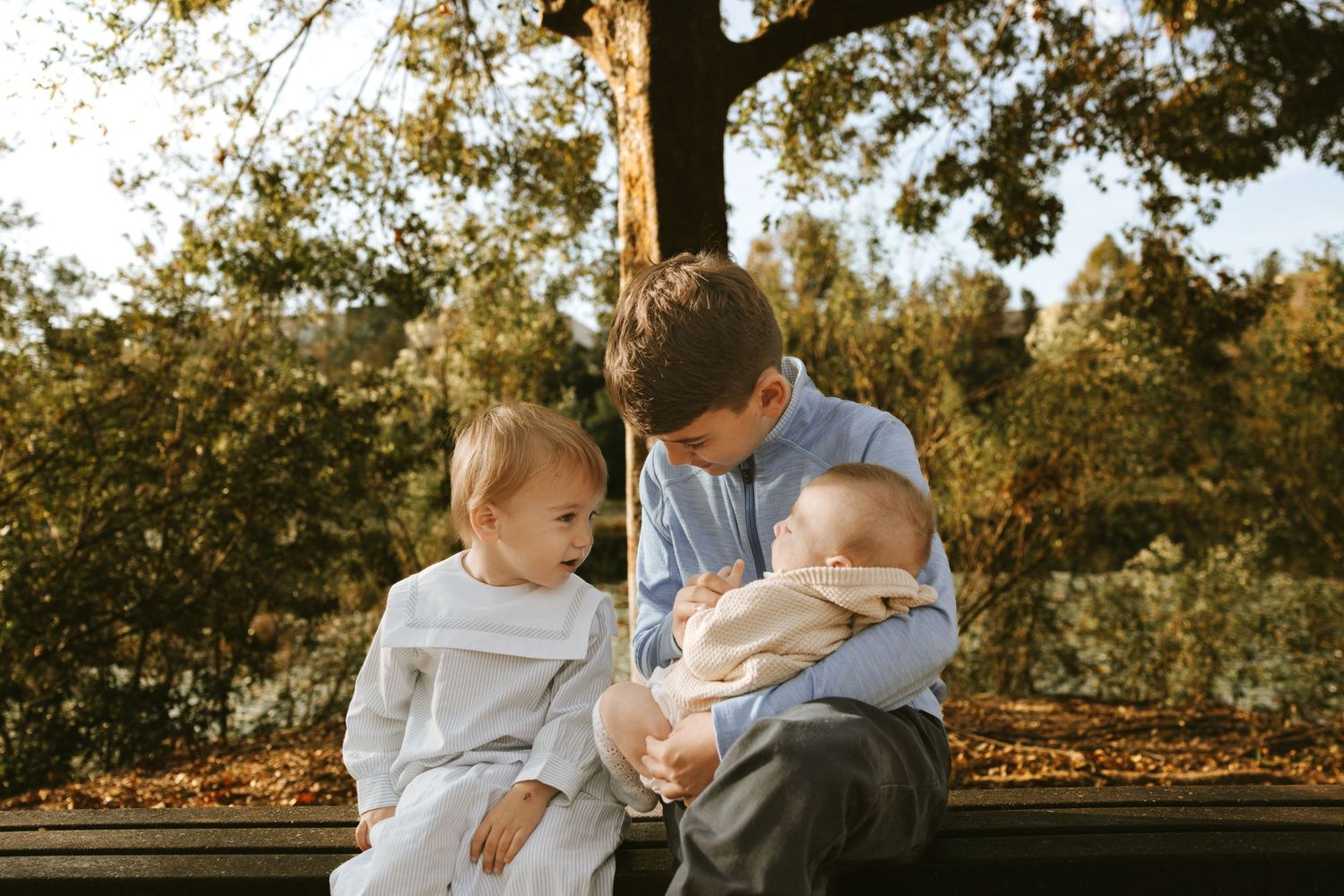 Young siblings sharing a quiet moment during a lifestyle family photo session in North Augusta