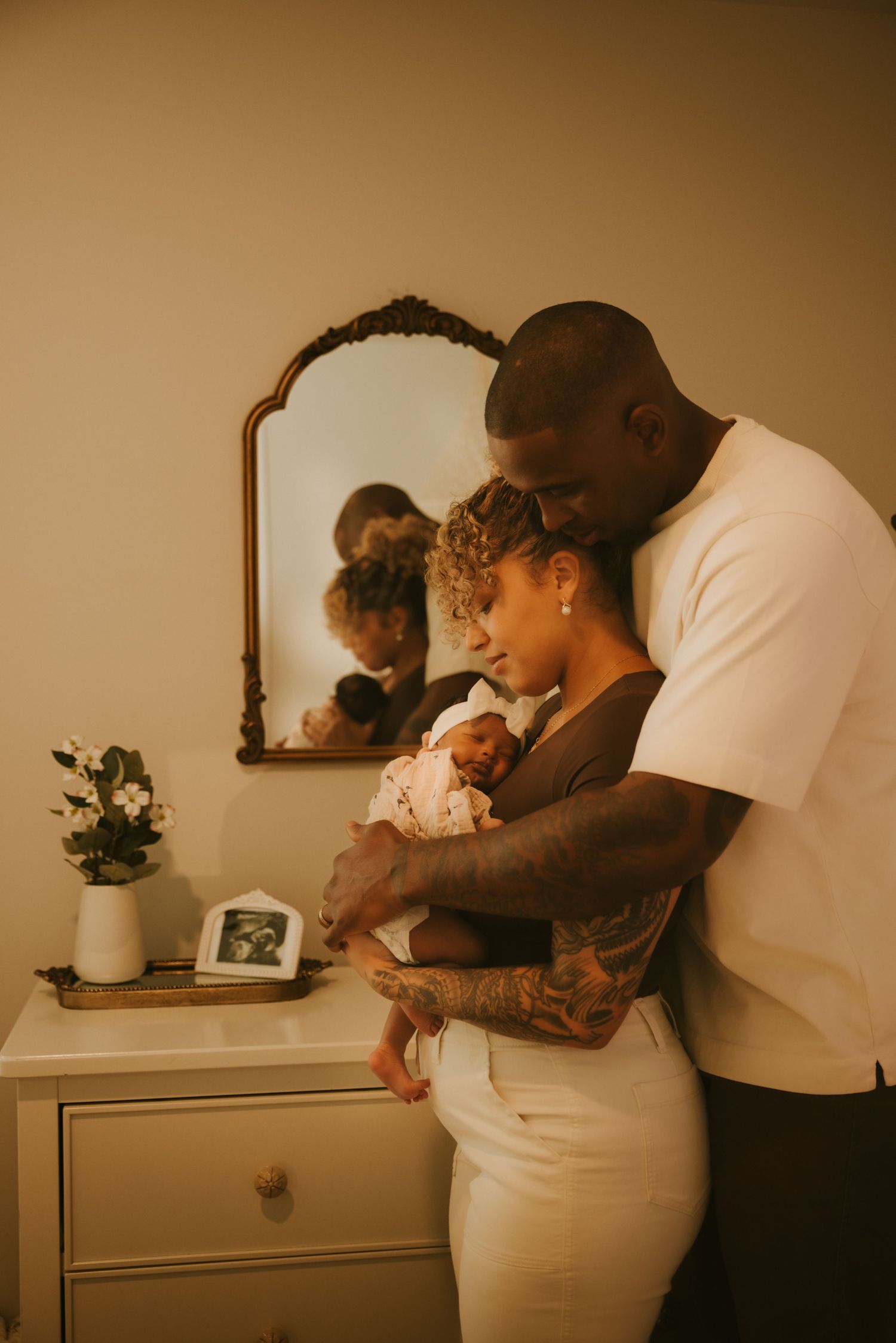 Parents bonding with their newborn during an in-home photo session in North Augusta, the CSRA.