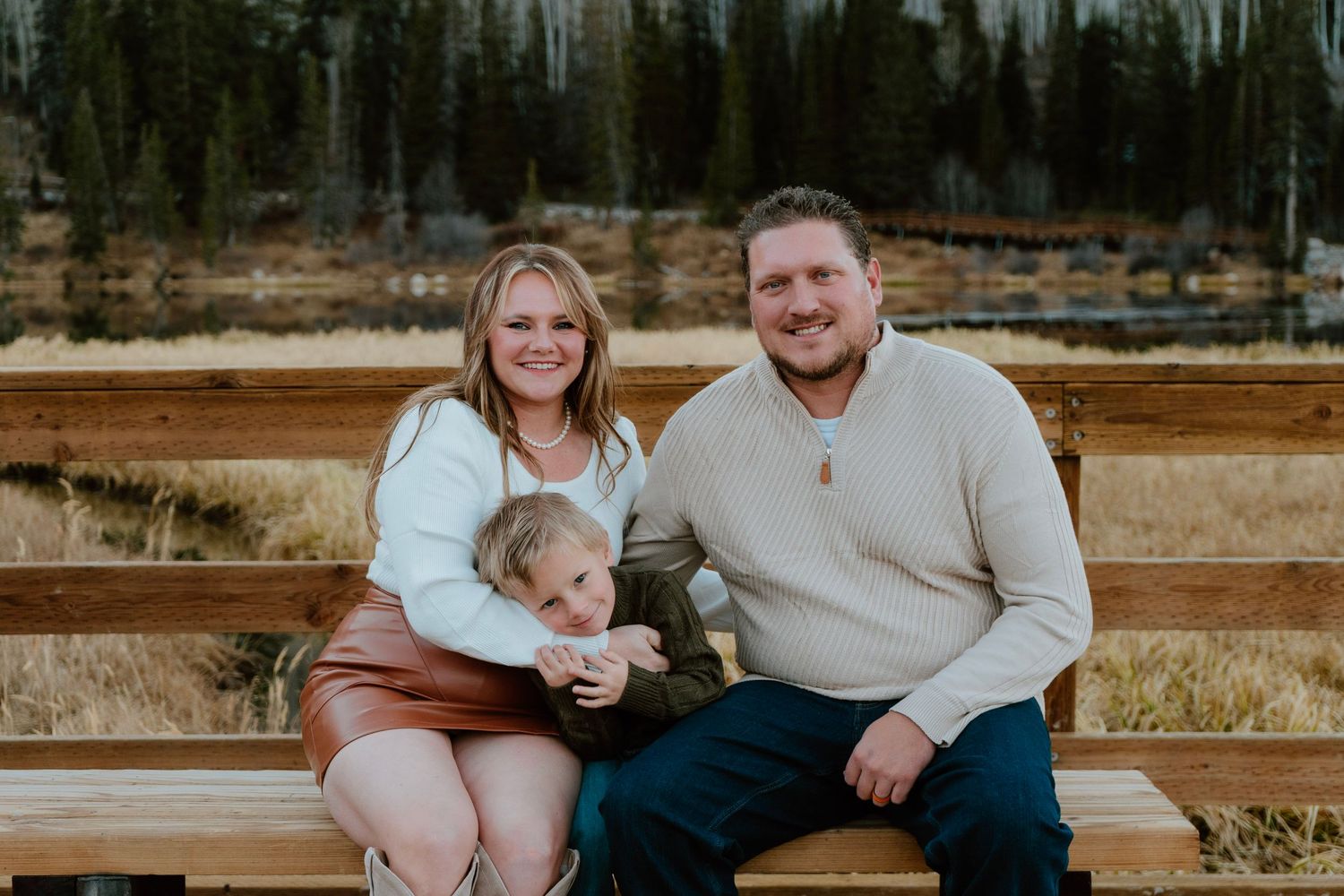 Candid family moment with son resting on his parents during mountain photo session