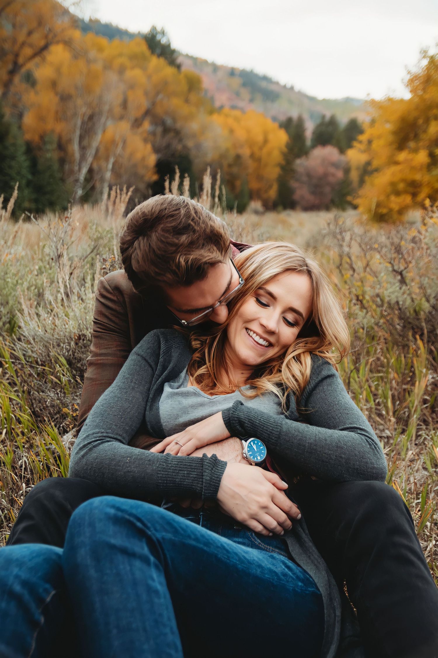 Couple cuddling in the mountains during romantic Utah photo session