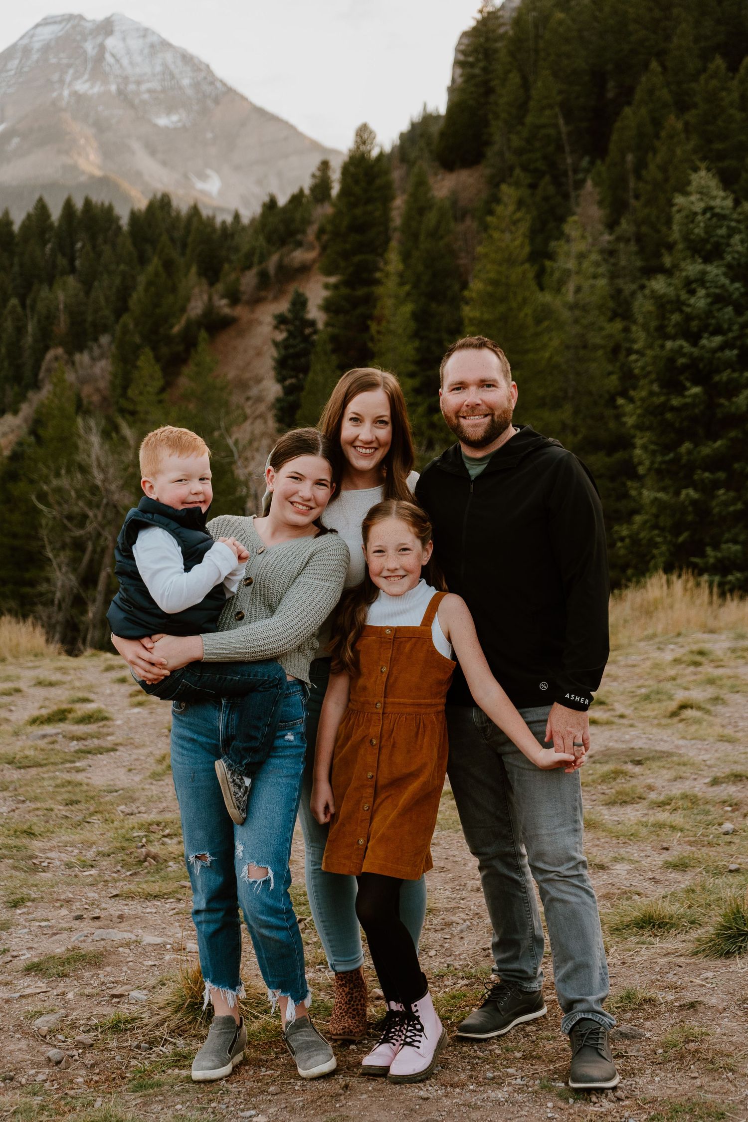 Family of five standing together in Utah mountains during outdoor session