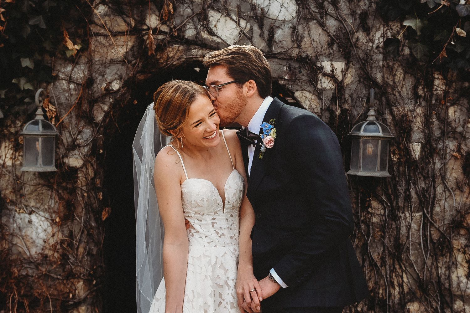 Bride and groom smiling together during romantic outdoor wedding portrait