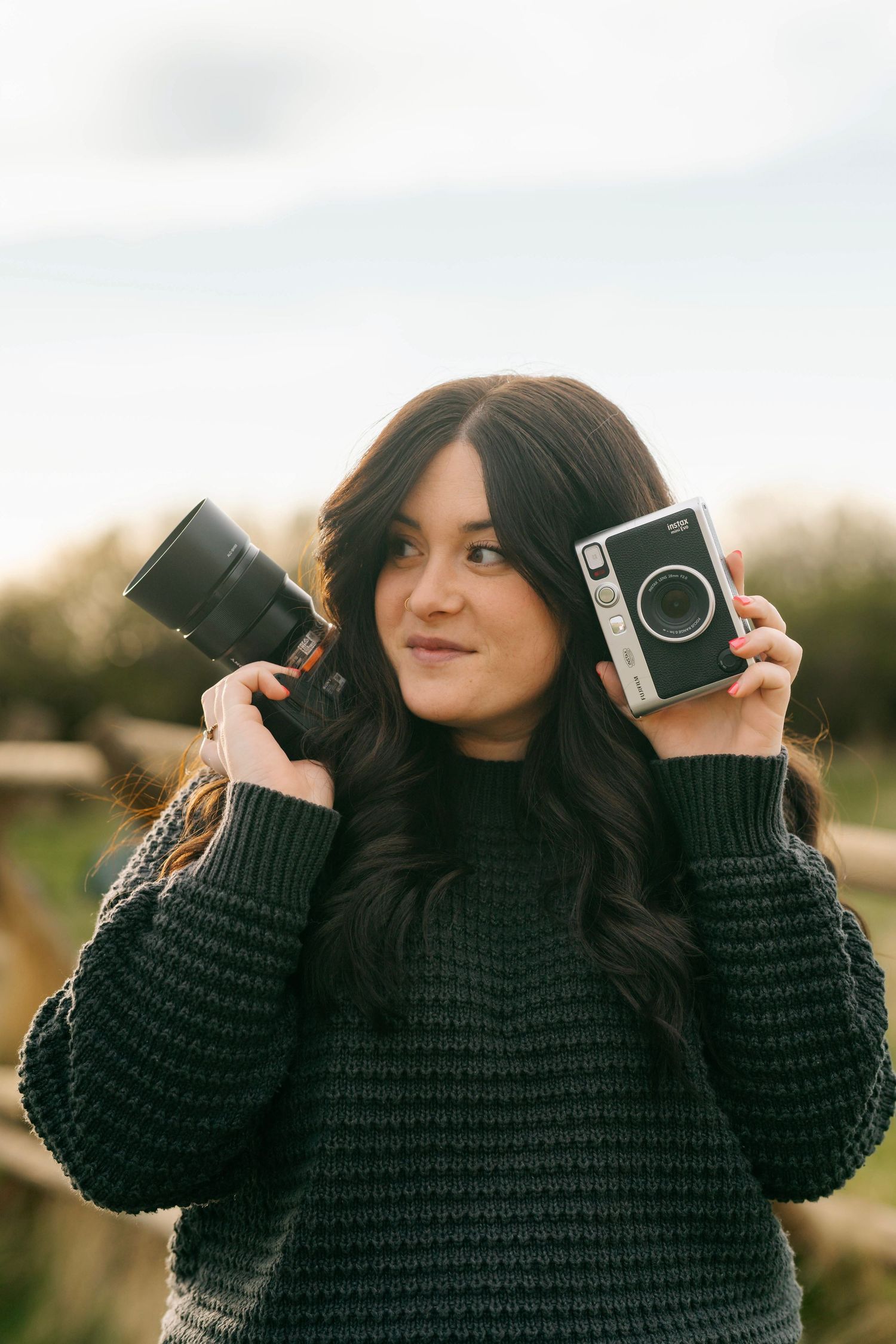 Utah photographer holding film camera and lens during personal branding session