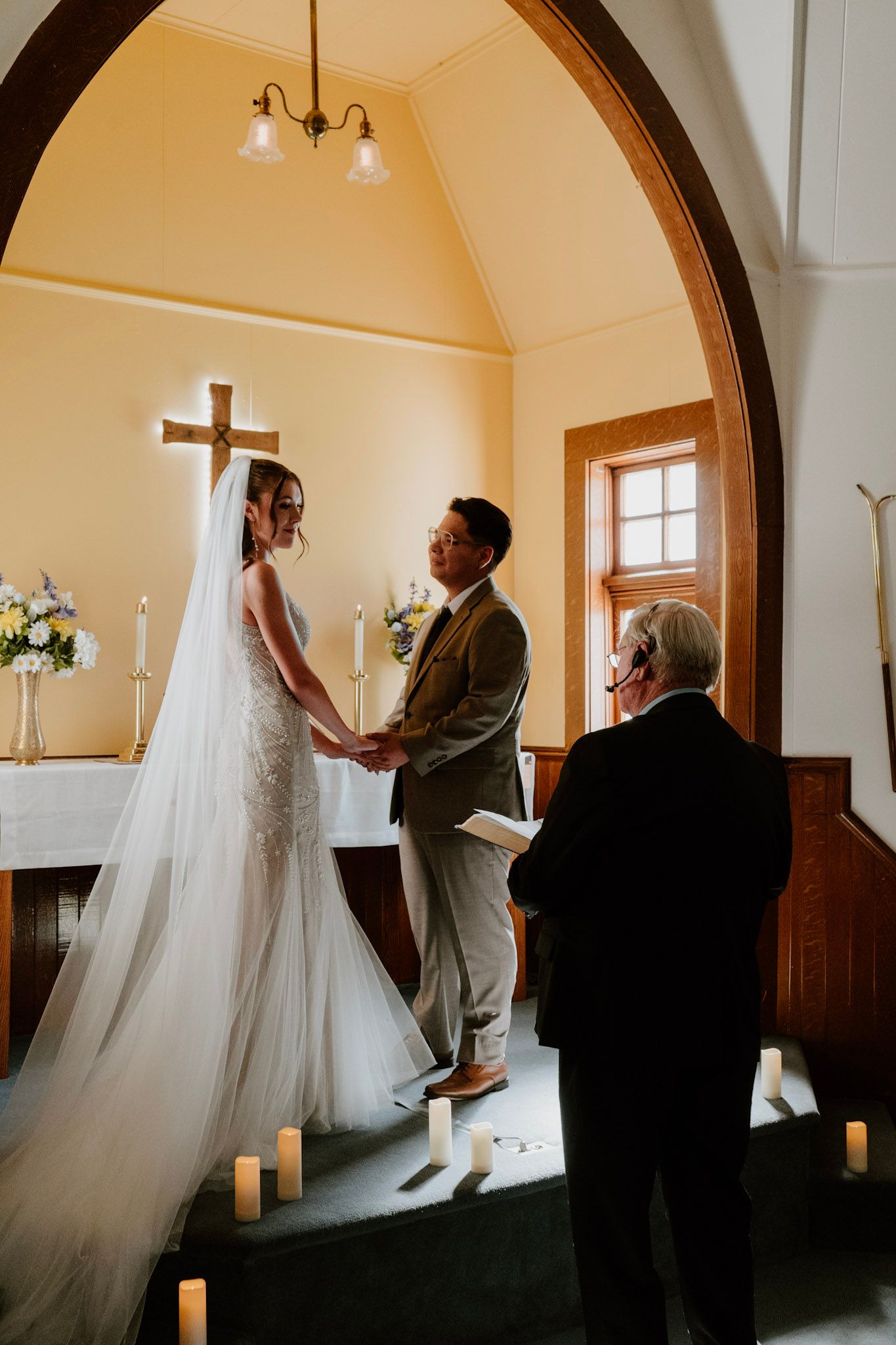 Bride and groom exchanging vows during intimate chapel wedding ceremony