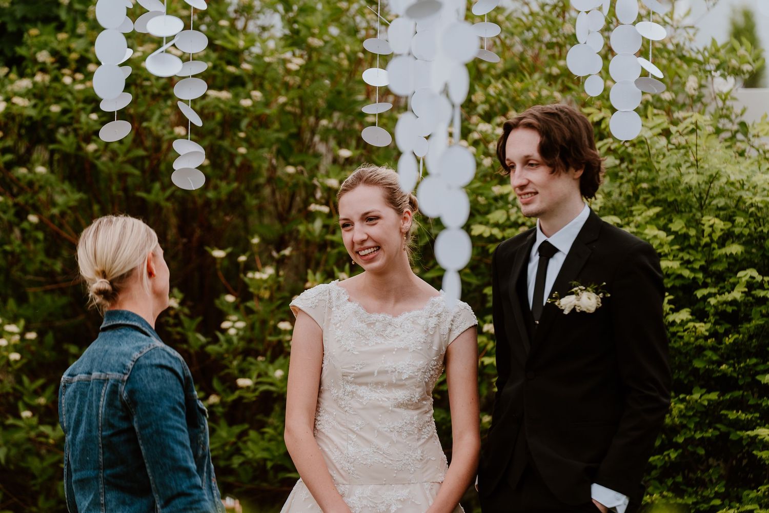 Bride and groom smiling during outdoor garden wedding ceremony