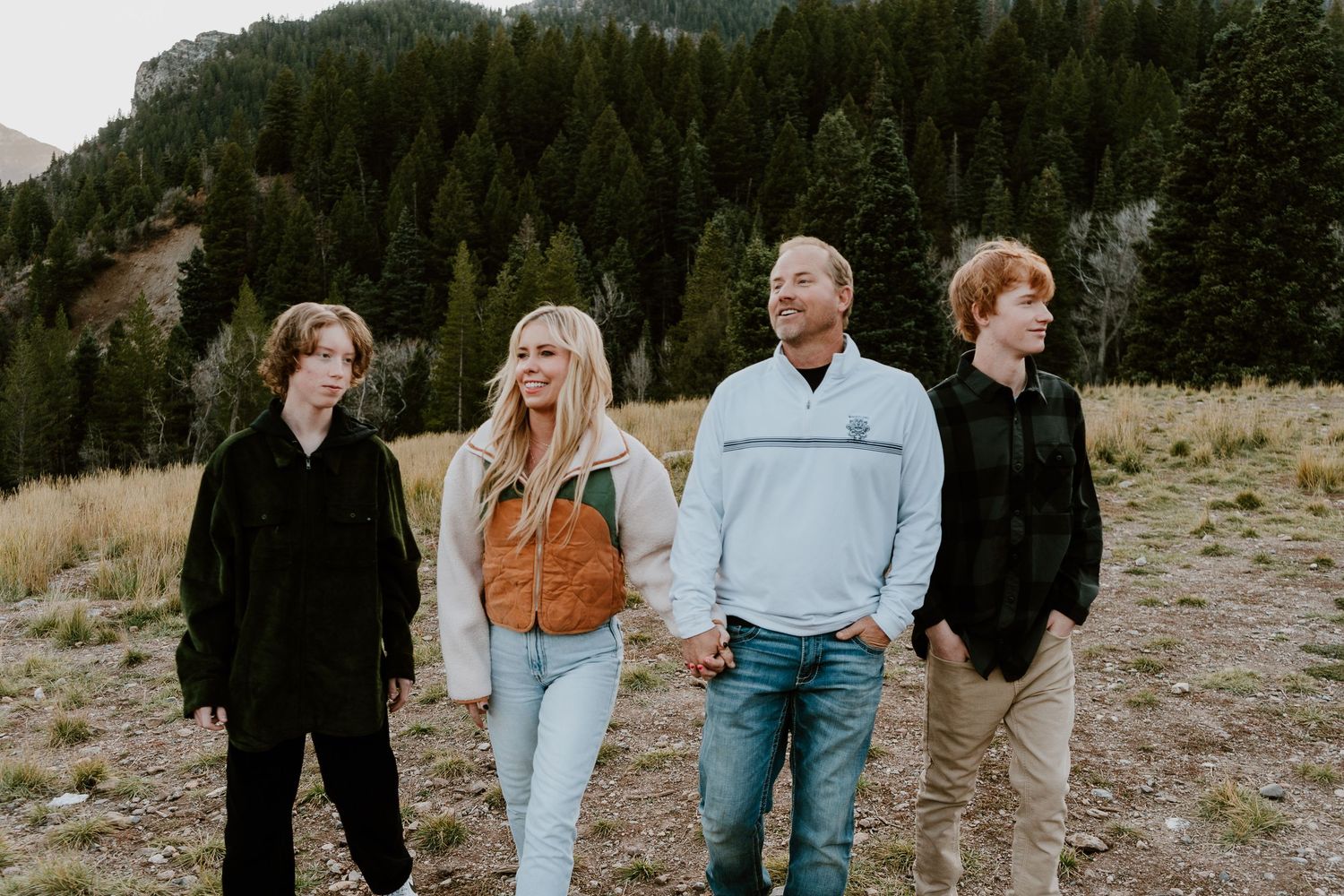 Family portrait in Utah mountains with parents and teenage sons outdoors