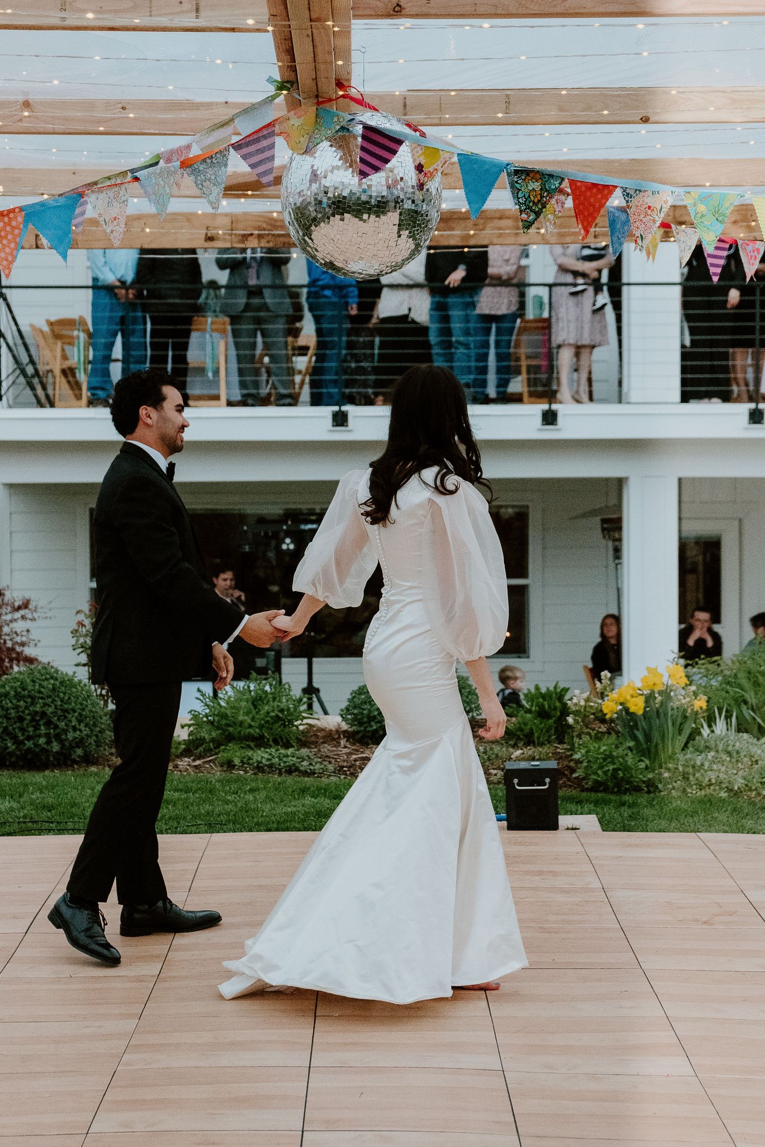 Bride and groom dancing outdoors at wedding reception celebration