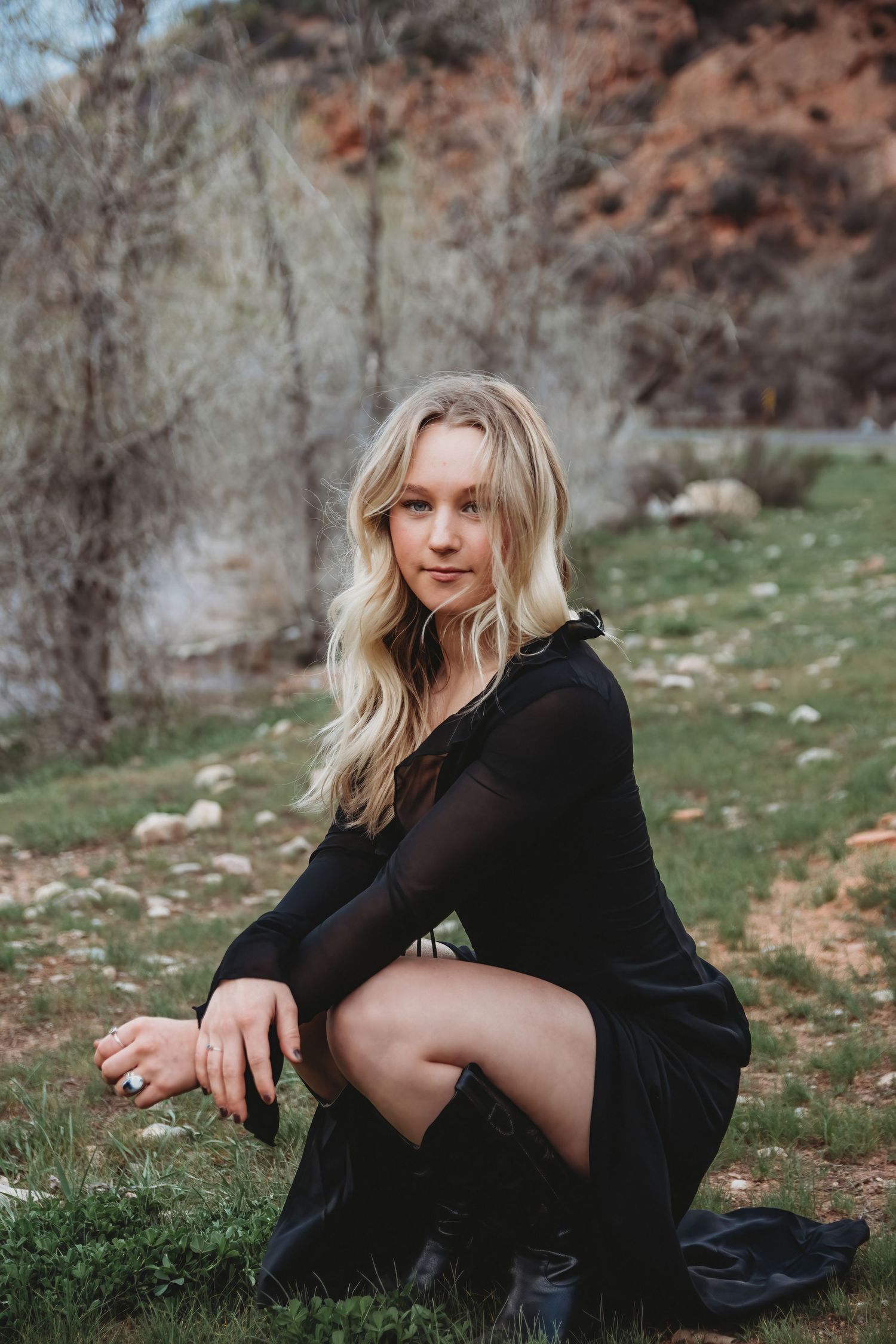 Blonde woman posing outdoors during moody lifestyle portrait session