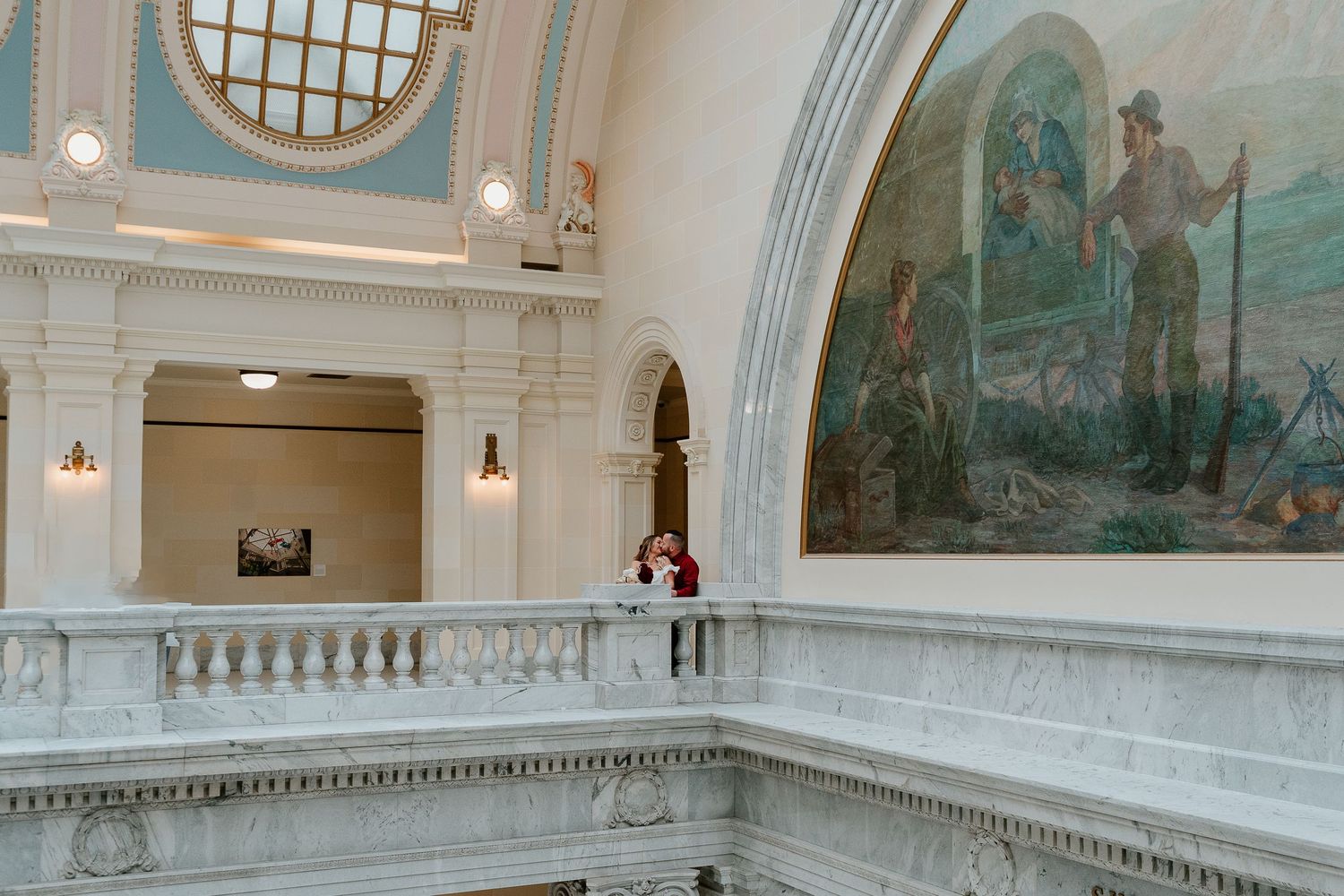 Couple portrait inside Utah State Capitol with elegant architecture backdrop