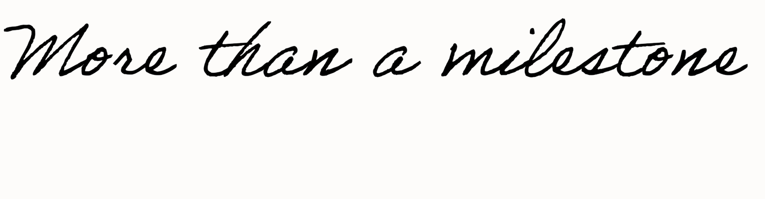 Stylish cursive script text on white background reading More than a milestone.