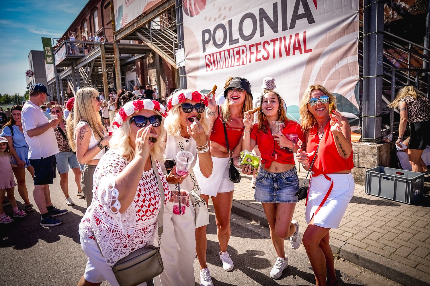 Women in festive attire celebrating at Polonia Summer Festival outdoor event on a sunny day.