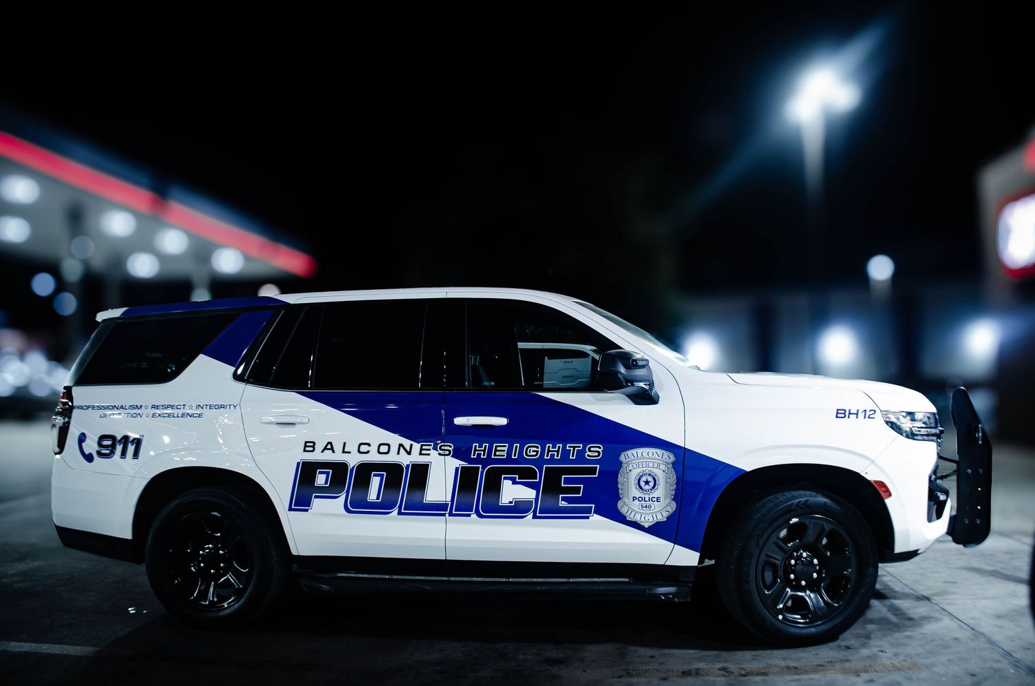 Balcones Heights Police Department SUV patrol car parked at night, featuring blue and white livery with 911 markings.