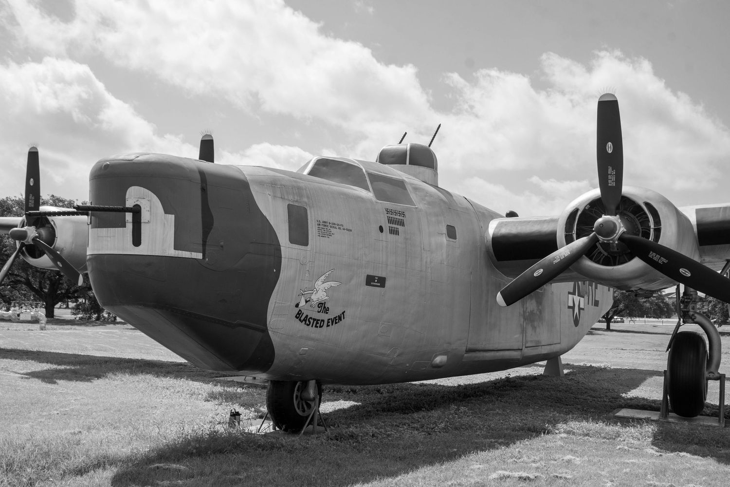 Vintage WWII B-24 Liberator bomber on display at an airshow, captured in black and white photography.