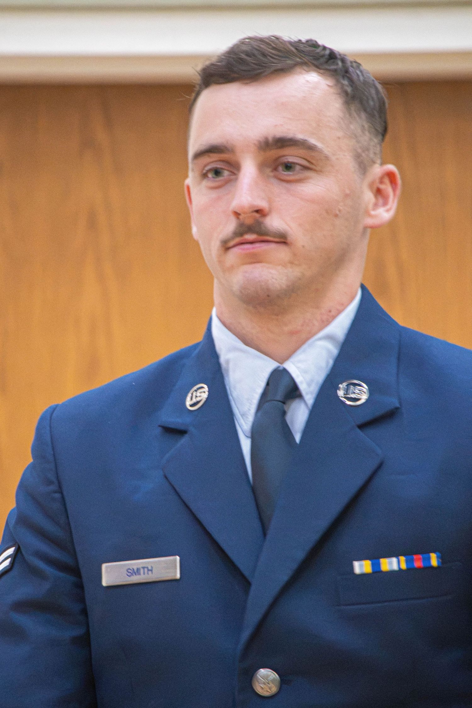 Male US Air Force airman named Smith in dress blue uniform with service ribbons and blue tie.