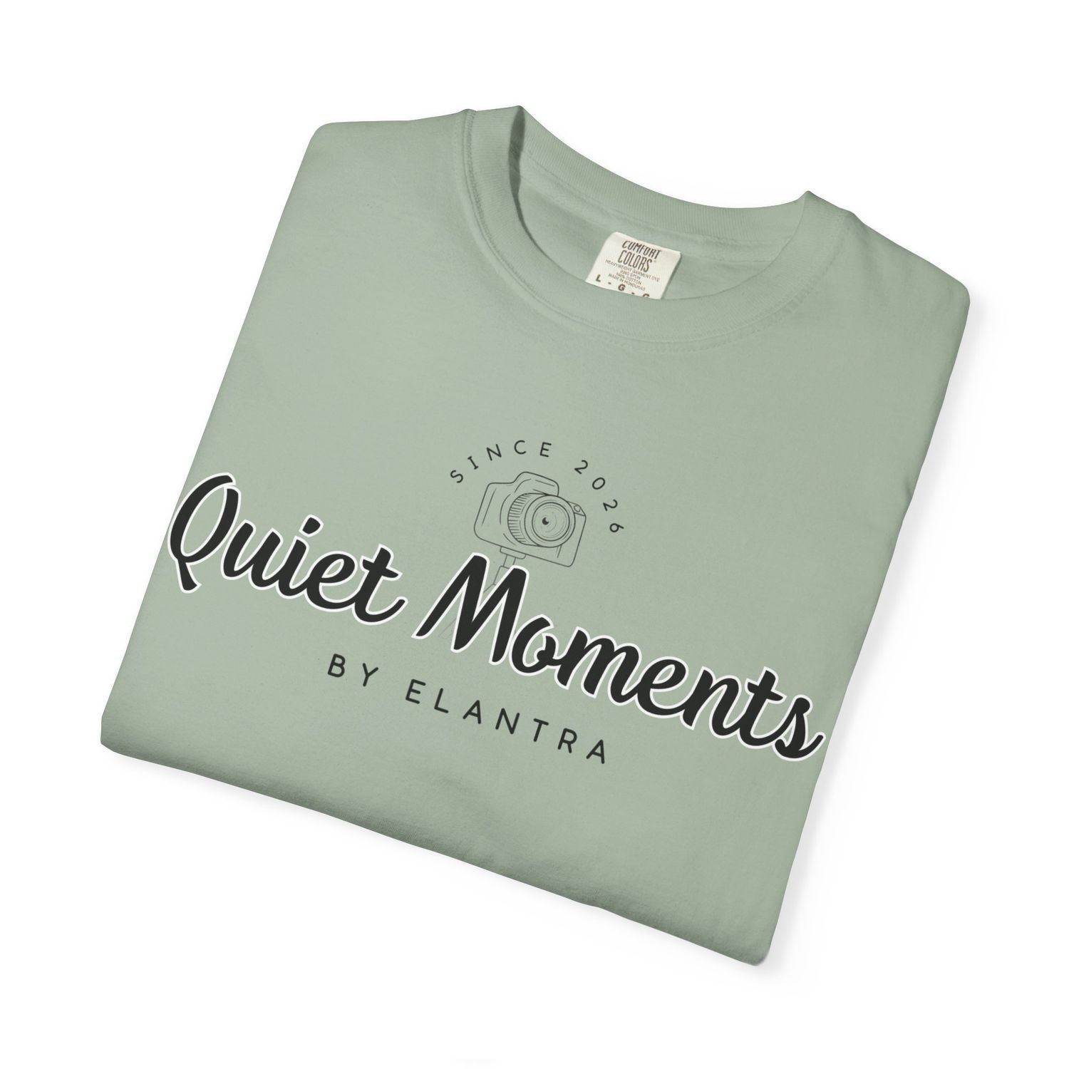 Sage green Quiet Moments by Elantra photography brand folded crew neck t-shirt with camera logo graphic.