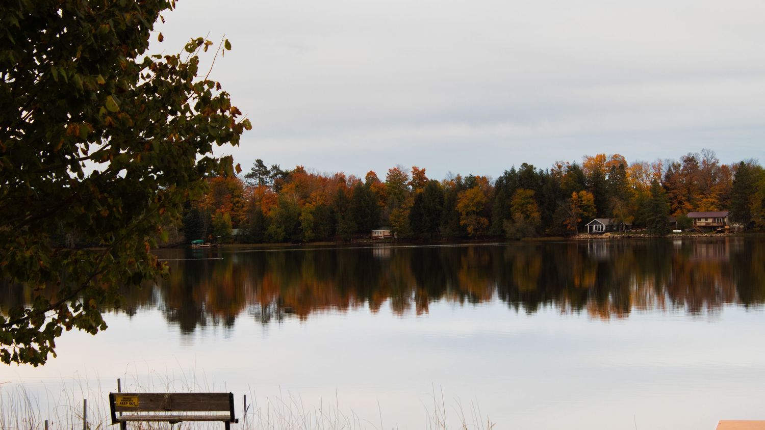 Calm lake with autumn trees reflecting on the water