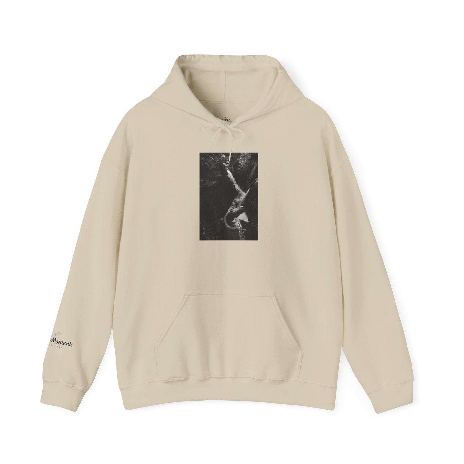 Sand-colored unisex hoodie featuring a black and white artistic graphic print on the chest and small logo on the sleeve.