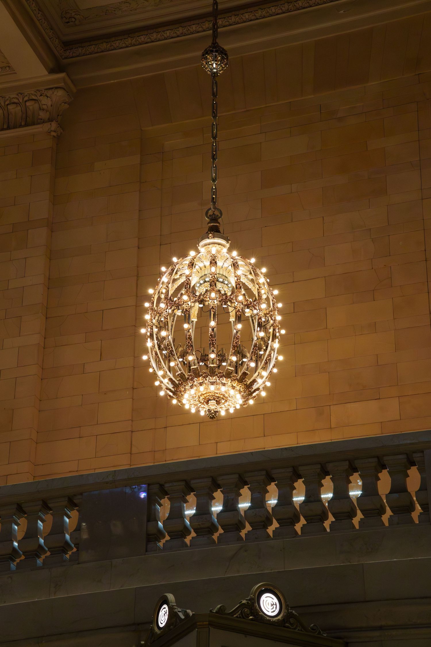 An ornate crystal chandelier hangs from the ceiling of Grand Central Terminal in New York.