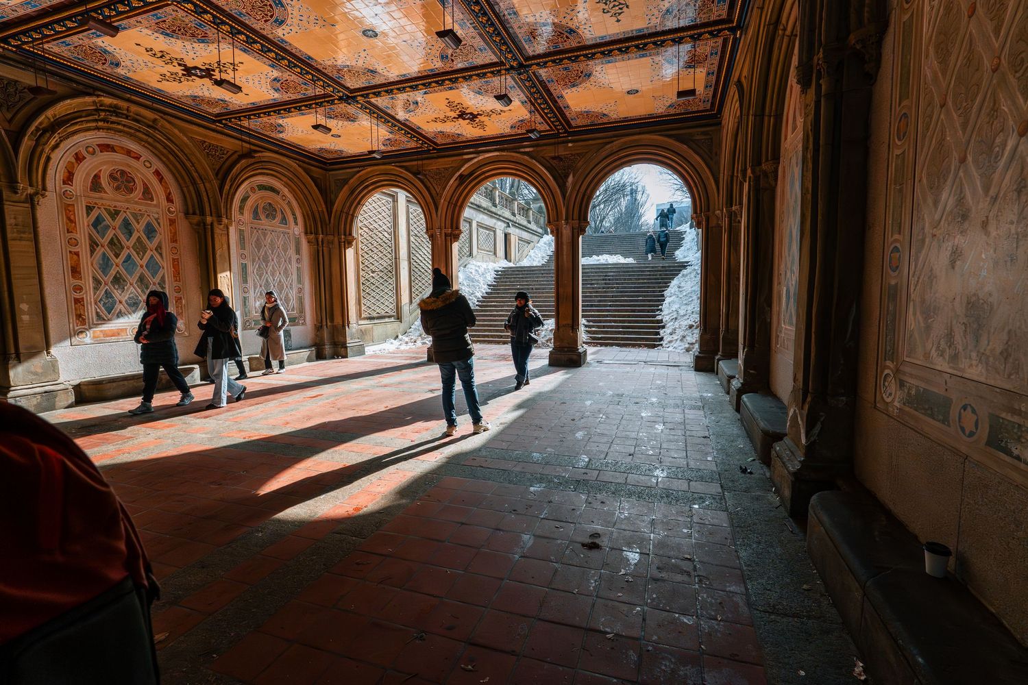 Bethesda Terrace arcade in Central Park with ornate painted ceiling and arched columns in winter.