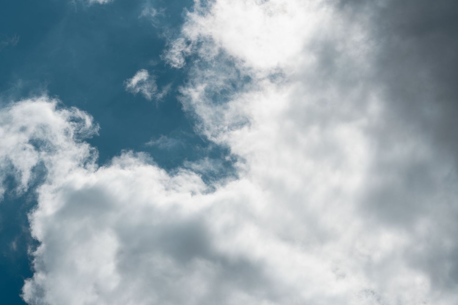 Soft white clouds spread across a blue sky creating a serene natural backdrop.