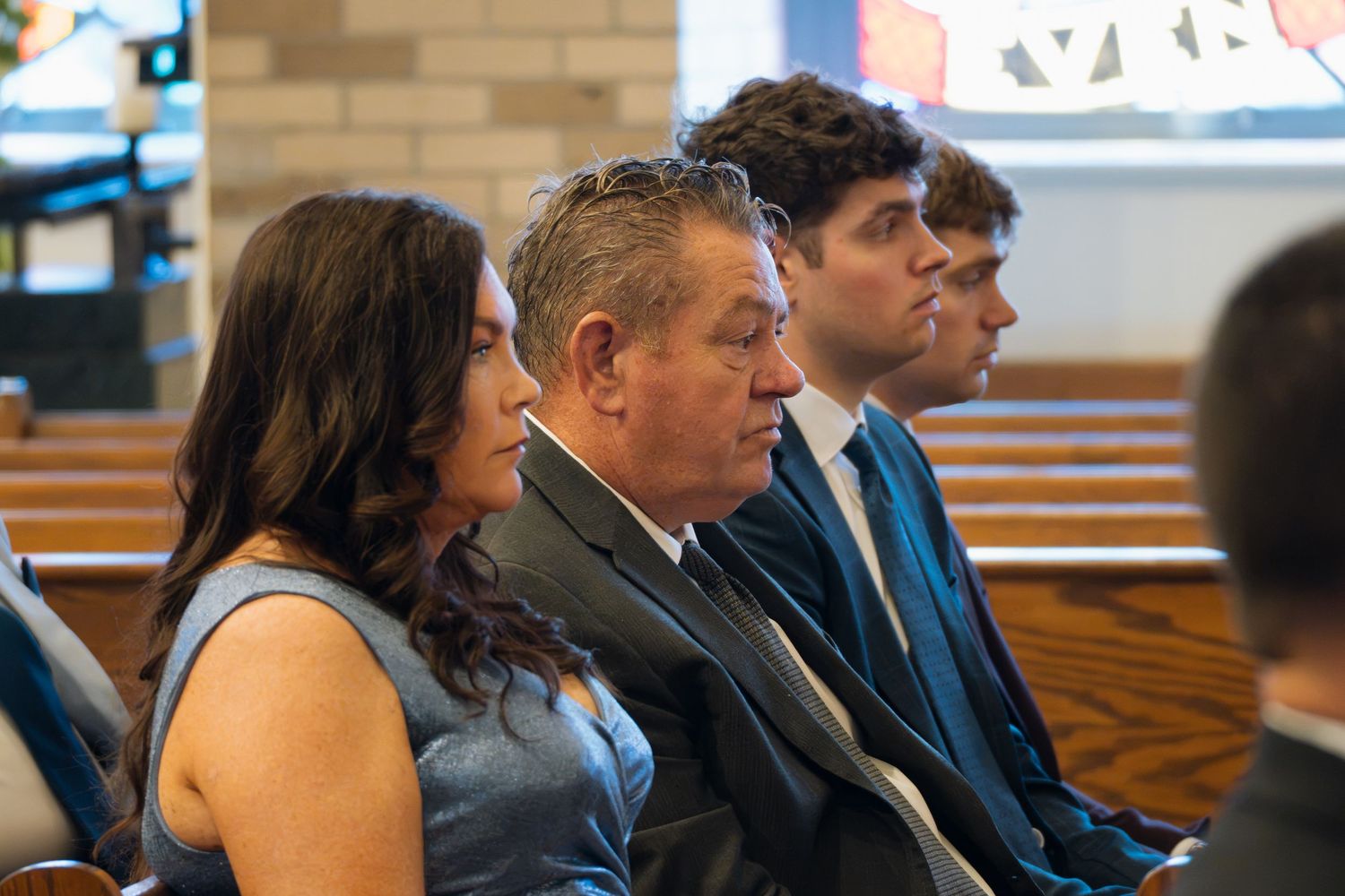 Group of professionals seated in rows at a formal event, attentively listening during a conference or ceremony.