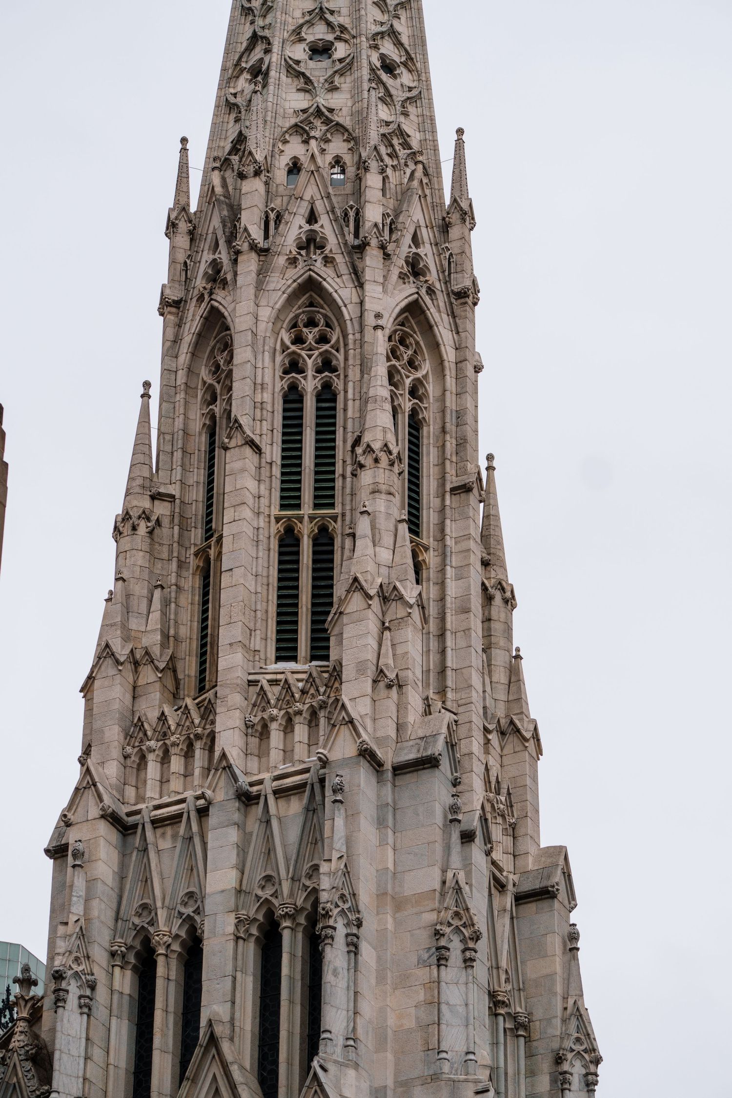Detailed Gothic stone spire and tower of St. Patrick's Cathedral in Midtown Manhattan, New York City.