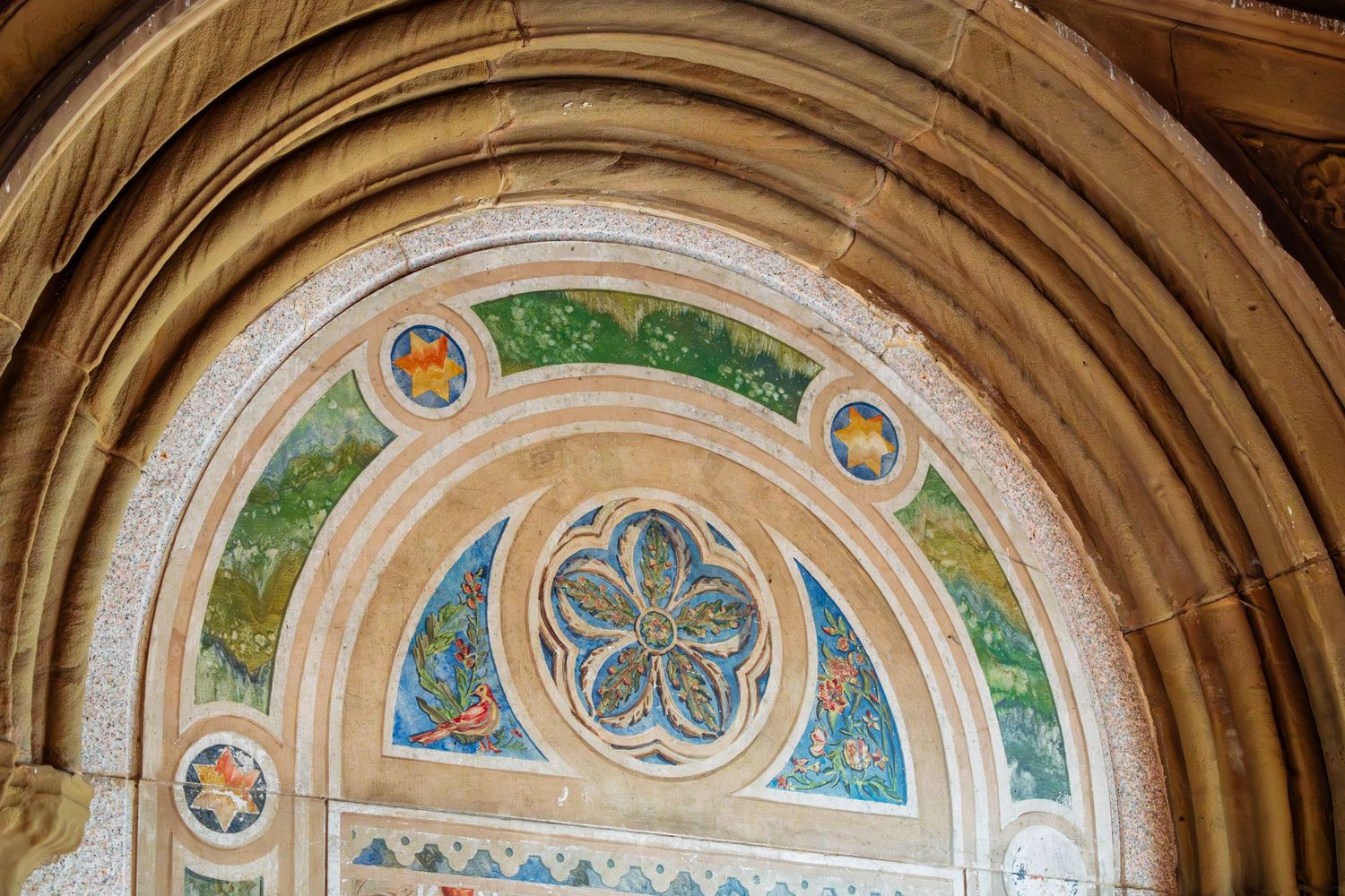 Ornate mosaic arch detail with floral medallion at Bethesda Terrace arcade in Central Park, NYC.