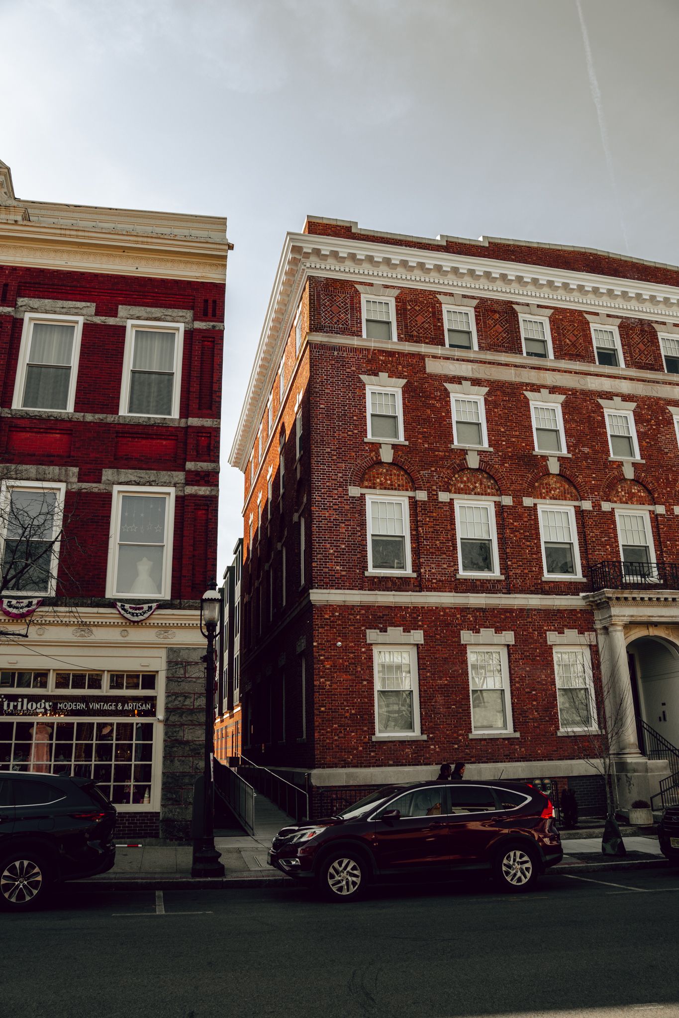 Classic red brick multi-story buildings on a quiet urban street corner.