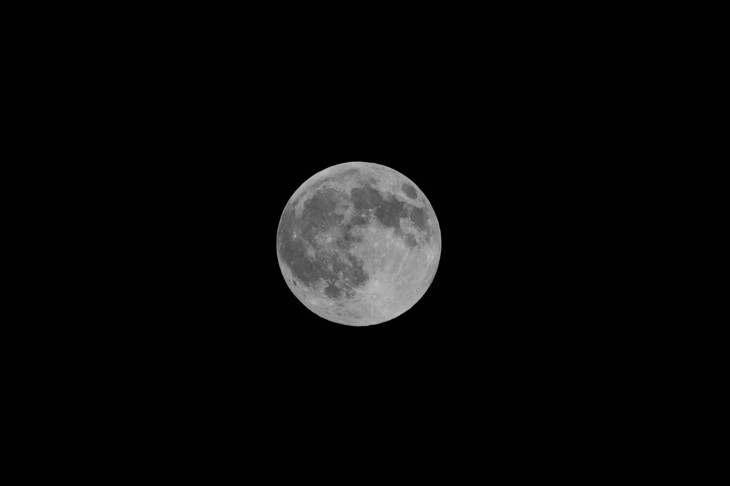 Detailed full moon with visible craters and surface features on a dark night sky.