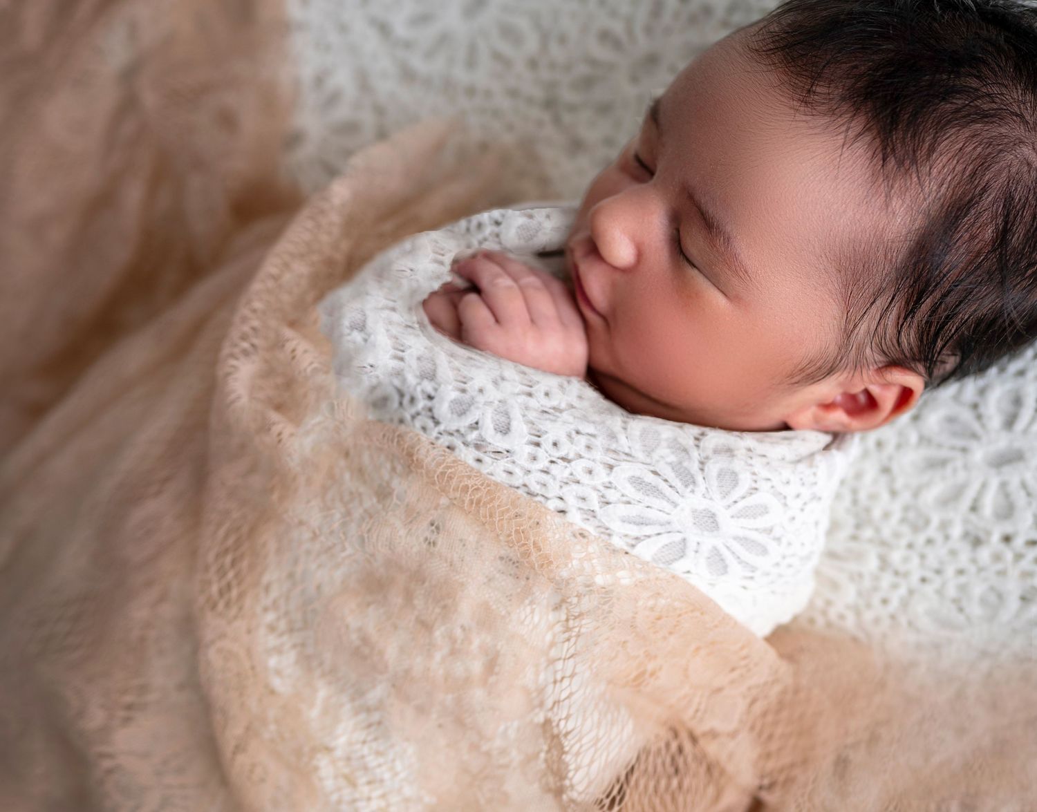 Sleeping newborn baby wrapped in neutral tones – Auckland newborn photography
