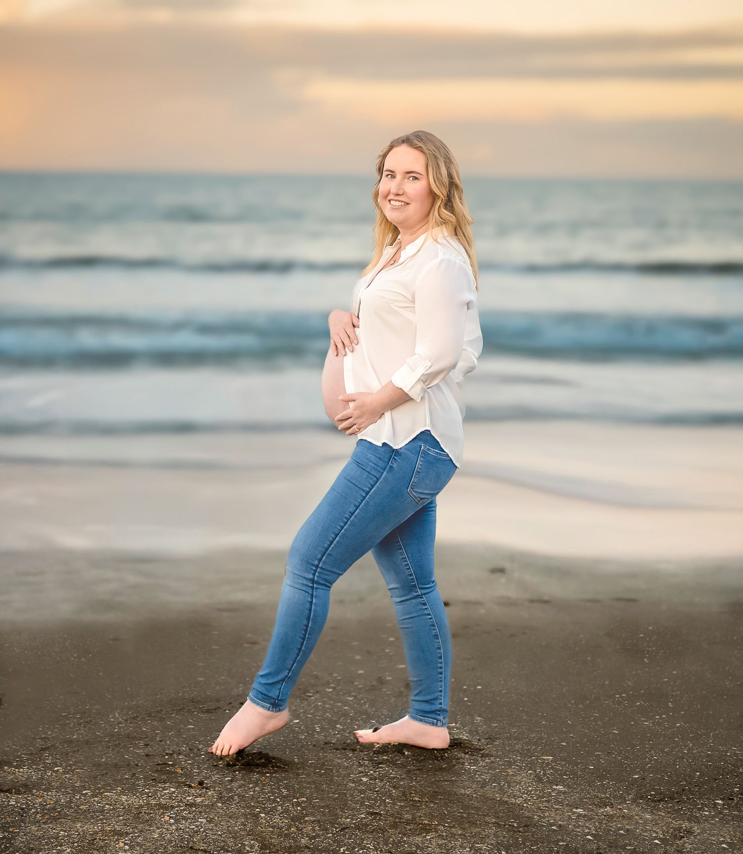 Pregnant woman walking on the beach at sunset – North Shore maternity photographer, long Bay Beach.