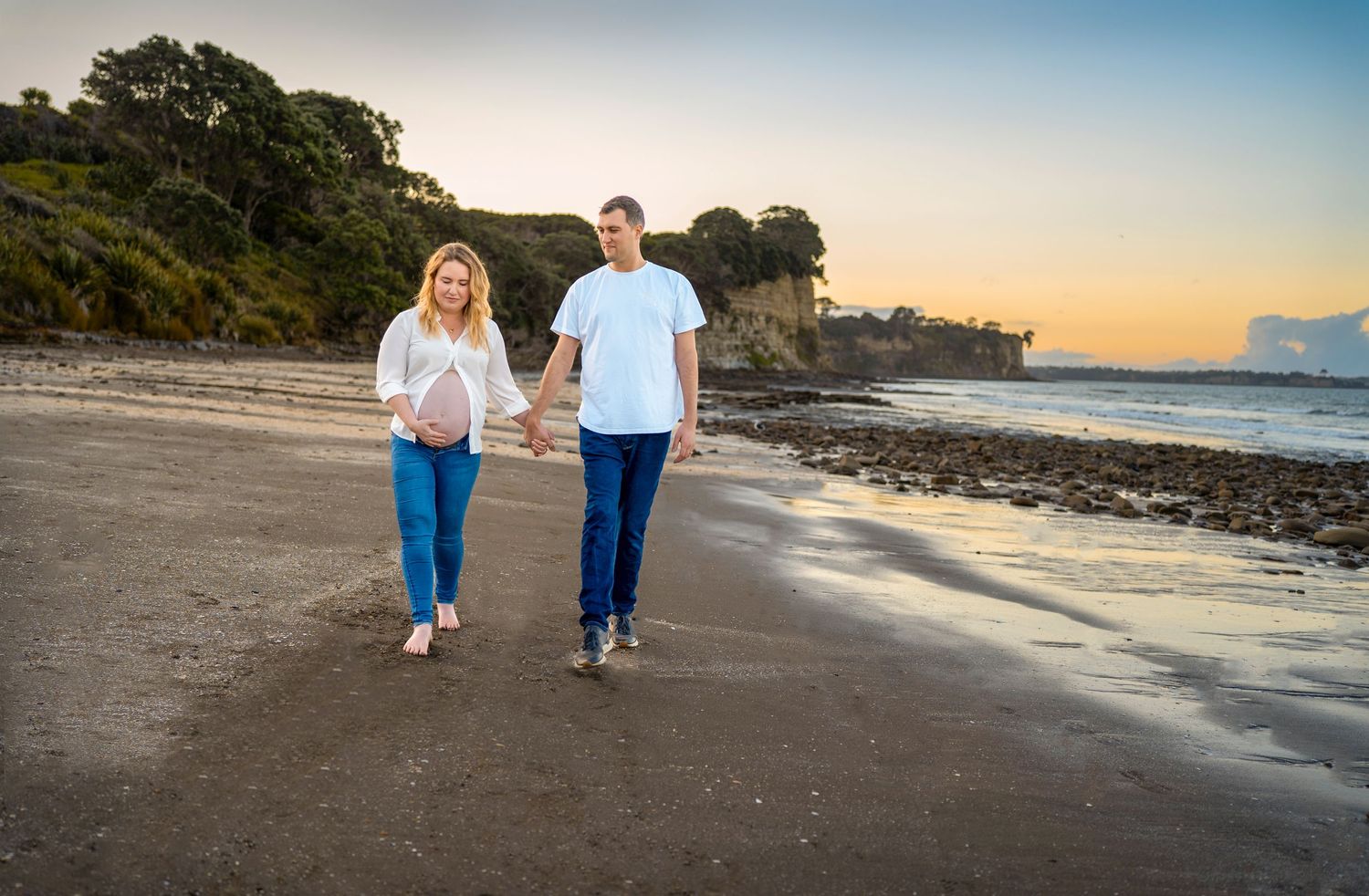 Expectant couple together on the beach at sunset – Auckland maternity photography, Long Bay Beach, North shore.