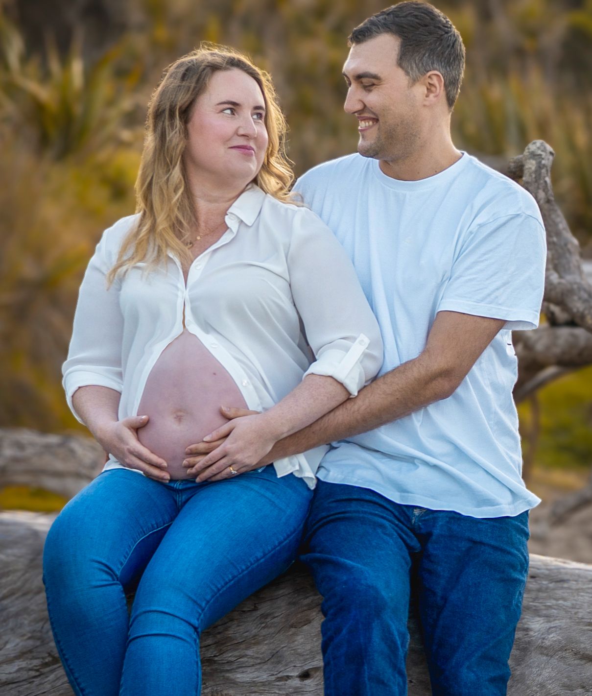 Long Bay Beach, North shore. Pregnant couple relaxing together outdoors – natural Auckland maternity photography