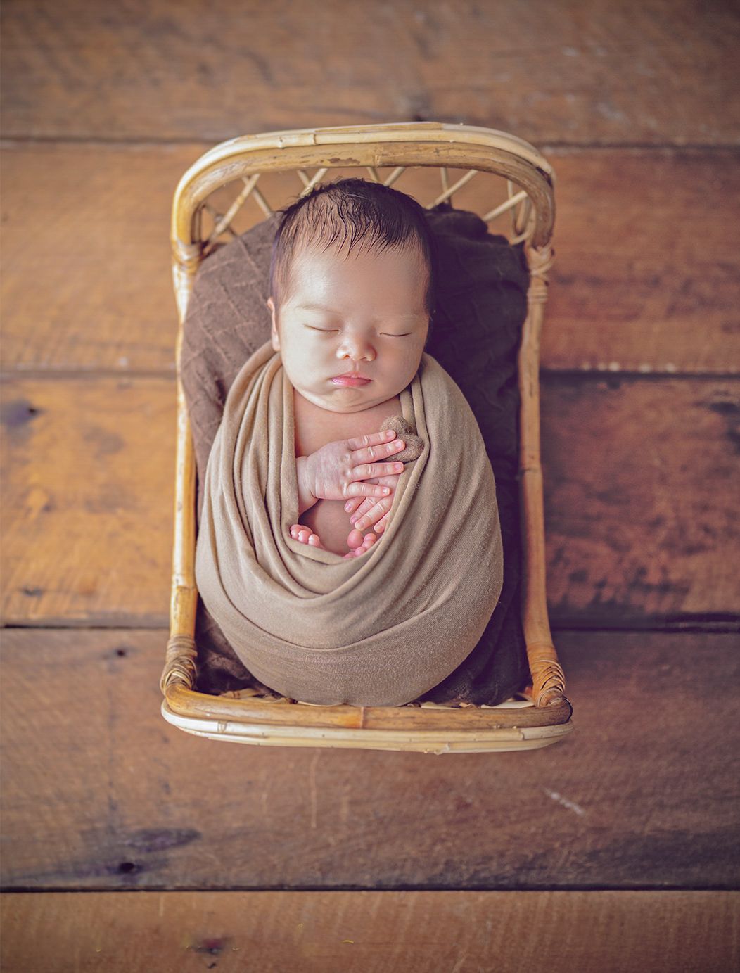 In studio Hillcrest North Shore, Newborn baby wrapped and posed in a rustic bed – studio newborn photography Hillcrest, Auckland North Shore