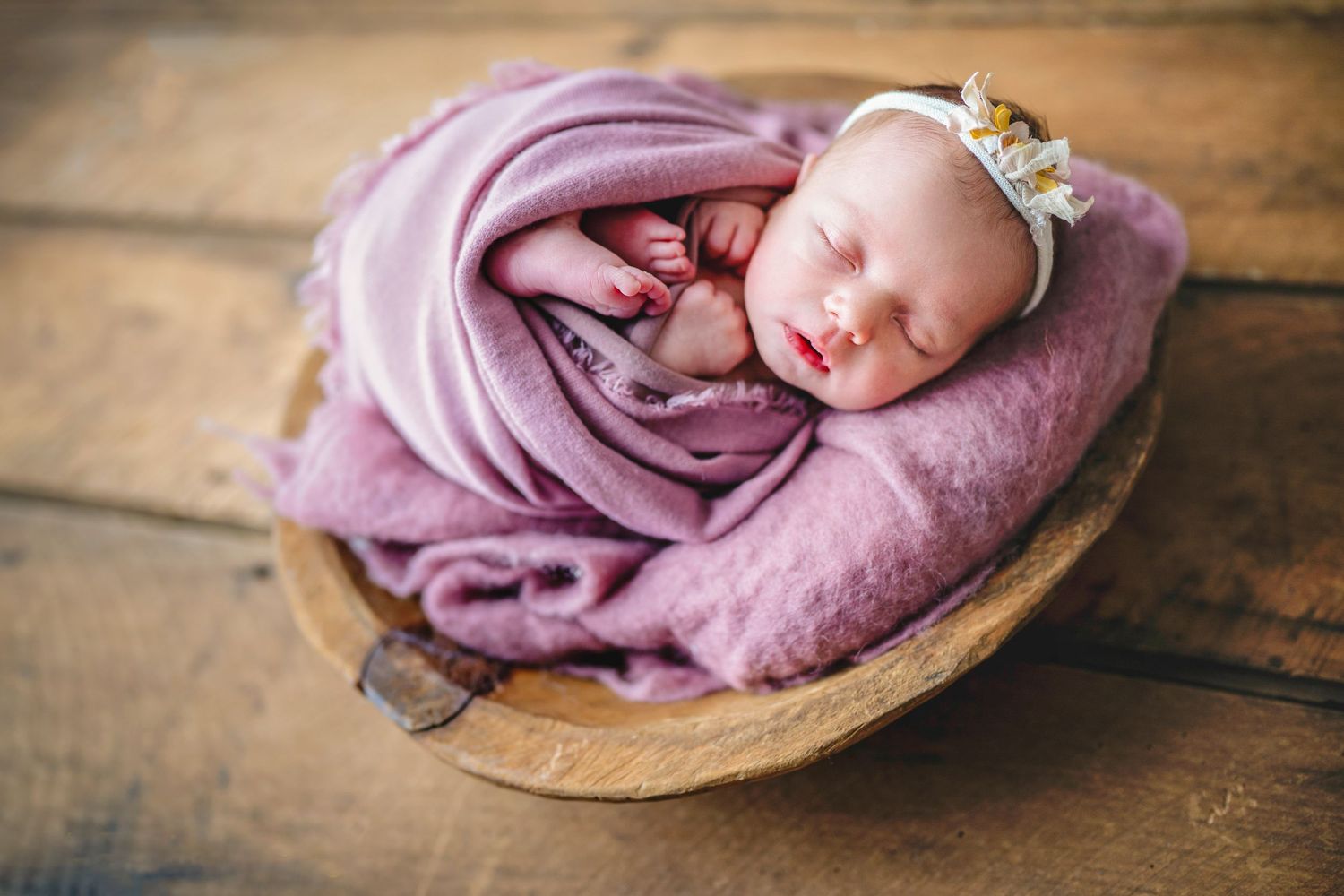 In studio Hillcrest North Shore, Sleeping newborn baby girl wrapped in pink and posed in a basket – newborn photographer Auckland North Shor
