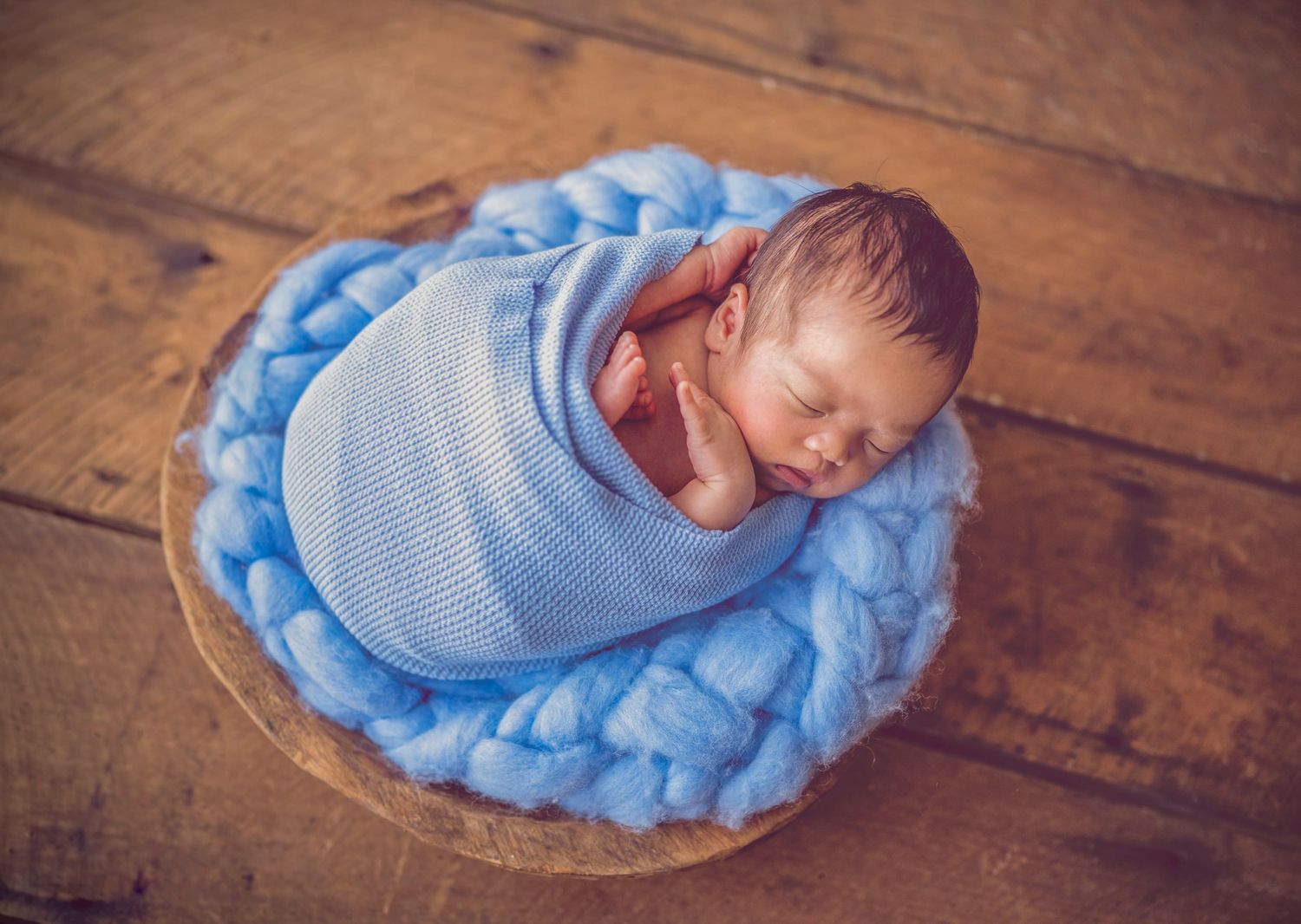 In studio Hillcrest North Shore, Newborn baby wrapped in blue and posed in basket – Auckland newborn photography
