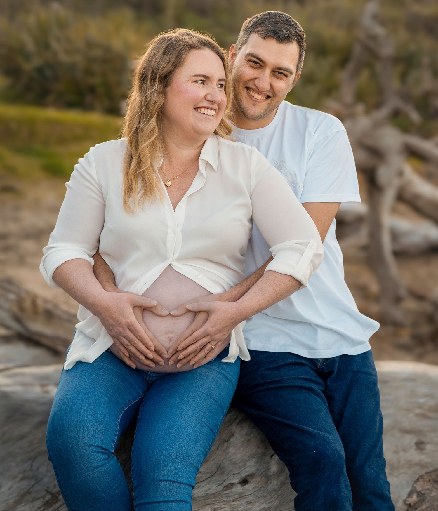 Long Bay Beach, North shore. Pregnant woman outdoors holding her baby bump – North Shore maternity photography