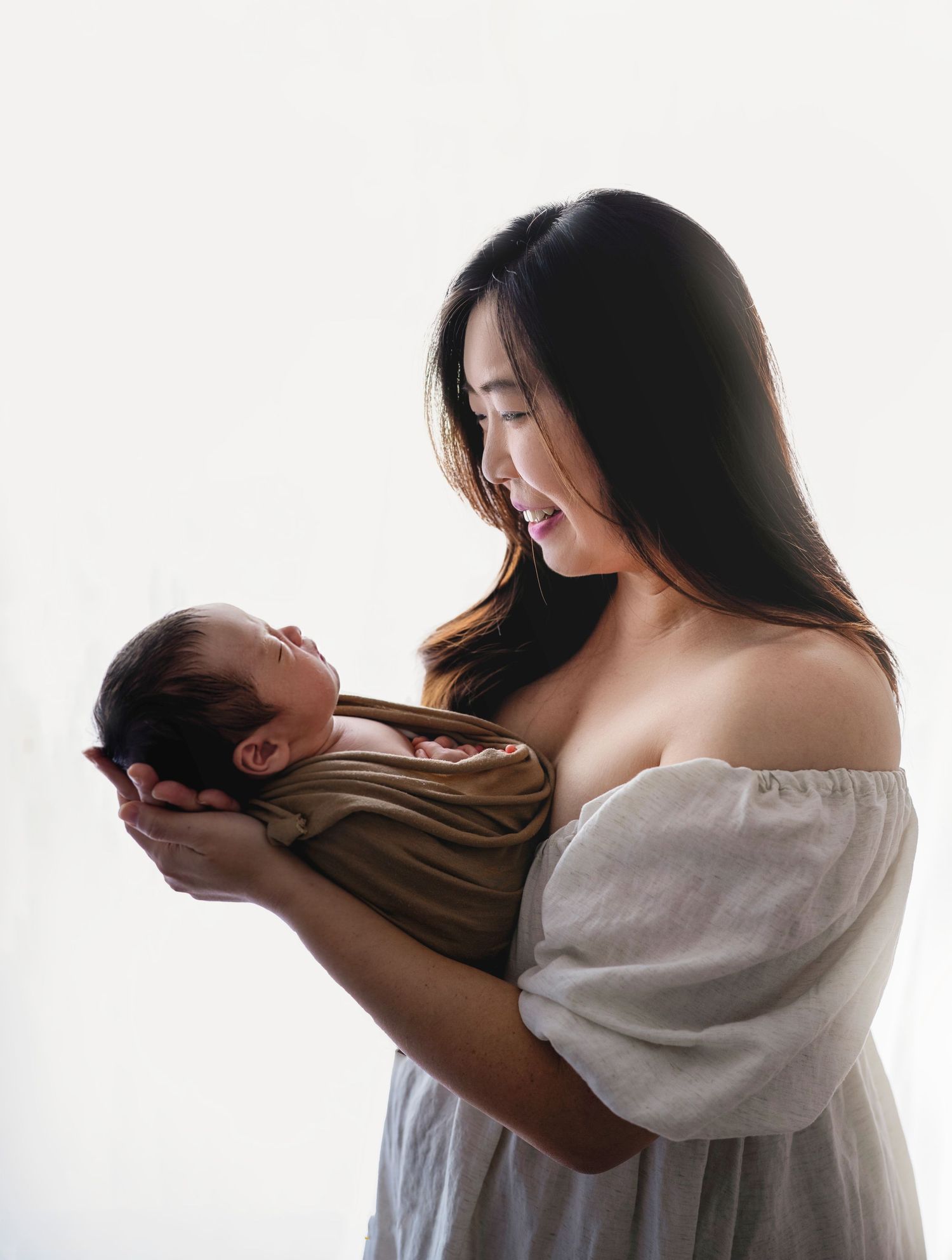 In studio Hillcrest North Shore, Mother holding newborn baby close – Auckland newborn photography