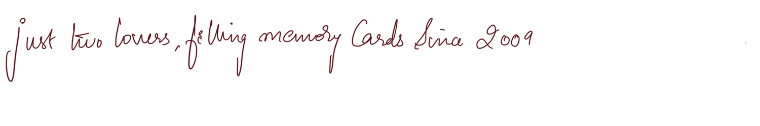 Handwritten note in blue ink reading just two lovers filling memory cards since 2009.