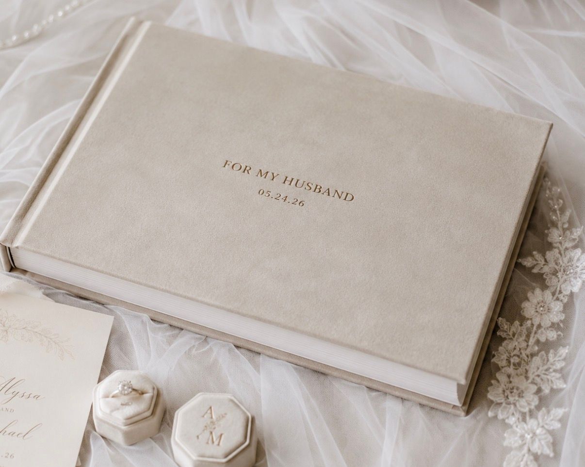 Elegant beige velvet keepsake box inscribed 'For My Husband' with wedding date, displayed on bridal veil with ring boxes.