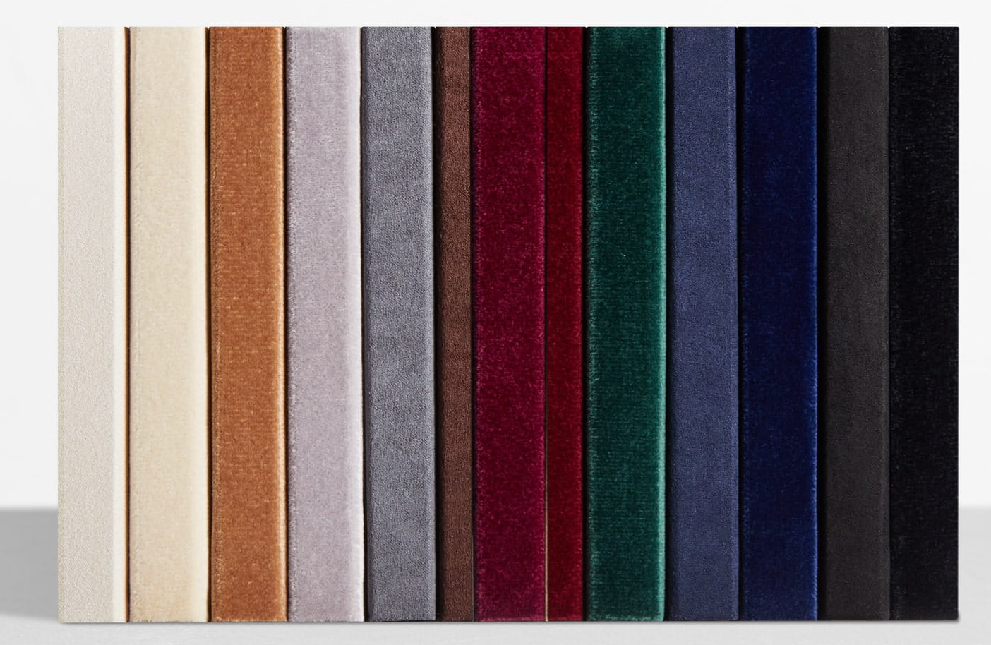 A collection of fabric swatches in various colors including beige, brown, gray, burgundy, green, navy, and black displayed vertically.