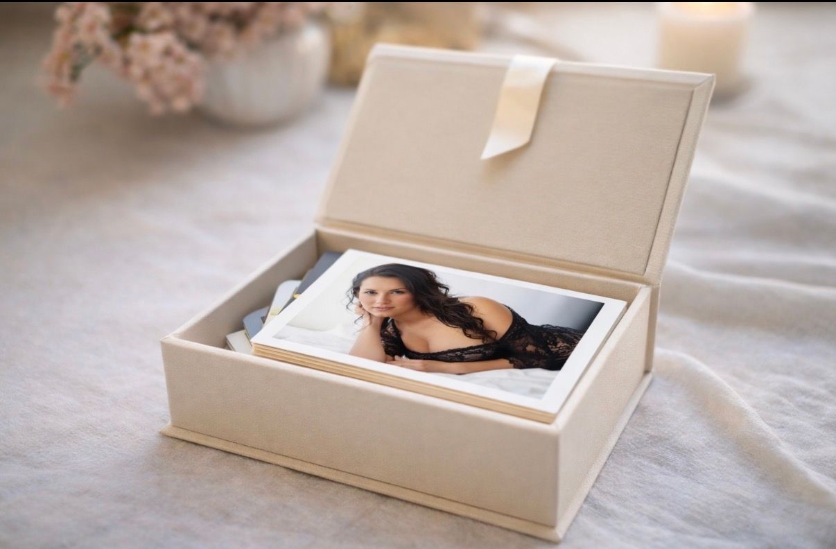 Elegant cream leather keepsake box open displaying a boudoir portrait photo, perfect for preserving cherished memories.