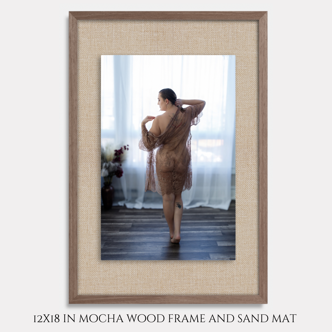 Woman posing with sheer wrap displayed in a 12x18 mocha wood frame with sand mat.