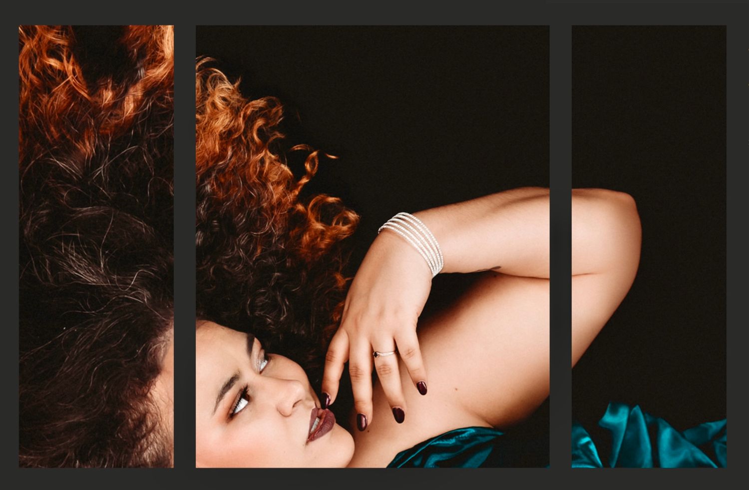 A woman with voluminous red curly hair poses gracefully, wearing a pearl bracelet against a dark background.