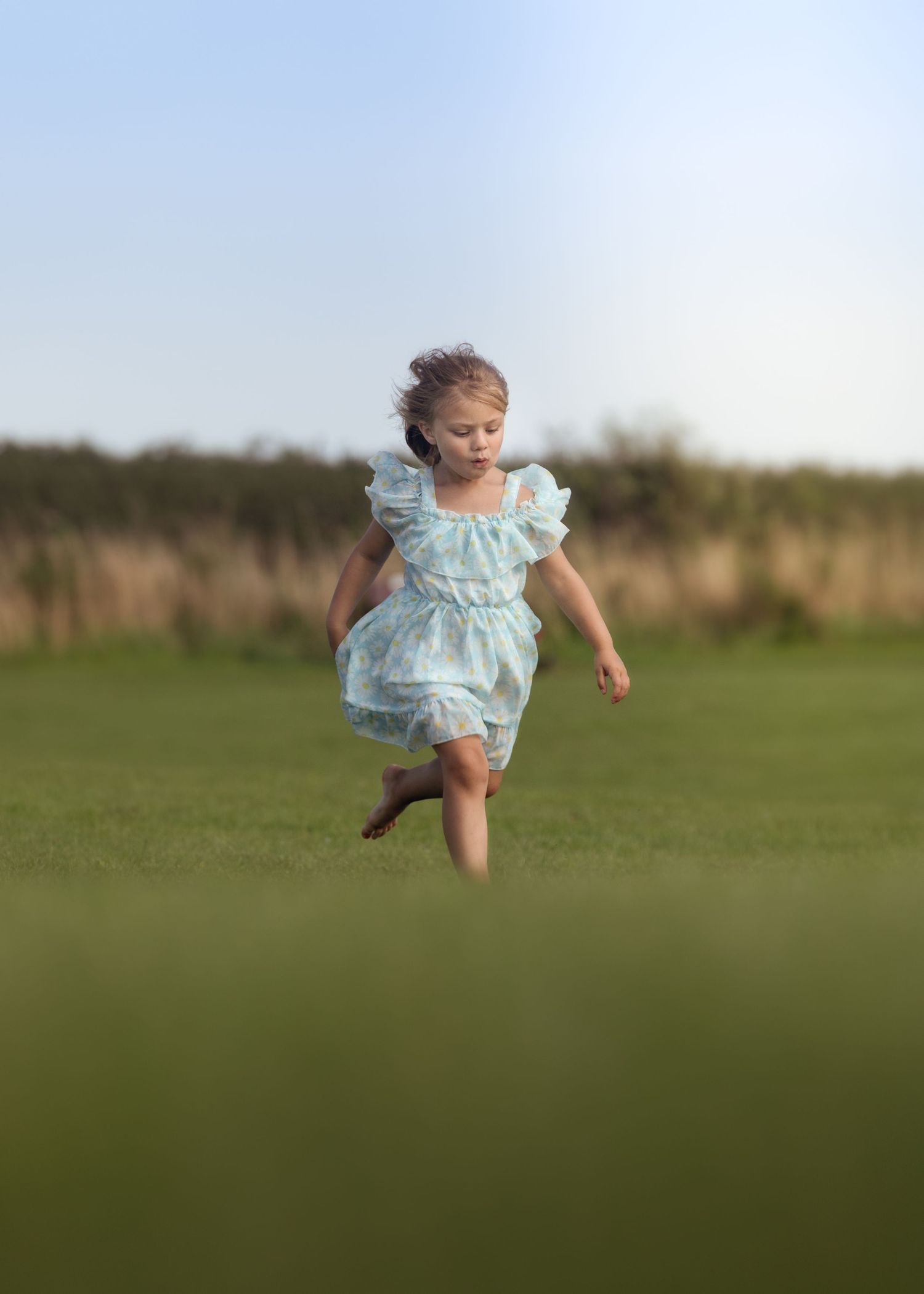 Young girl in a light blue dress running barefoot across a green field.

Blue Dolphin North Yorkshire