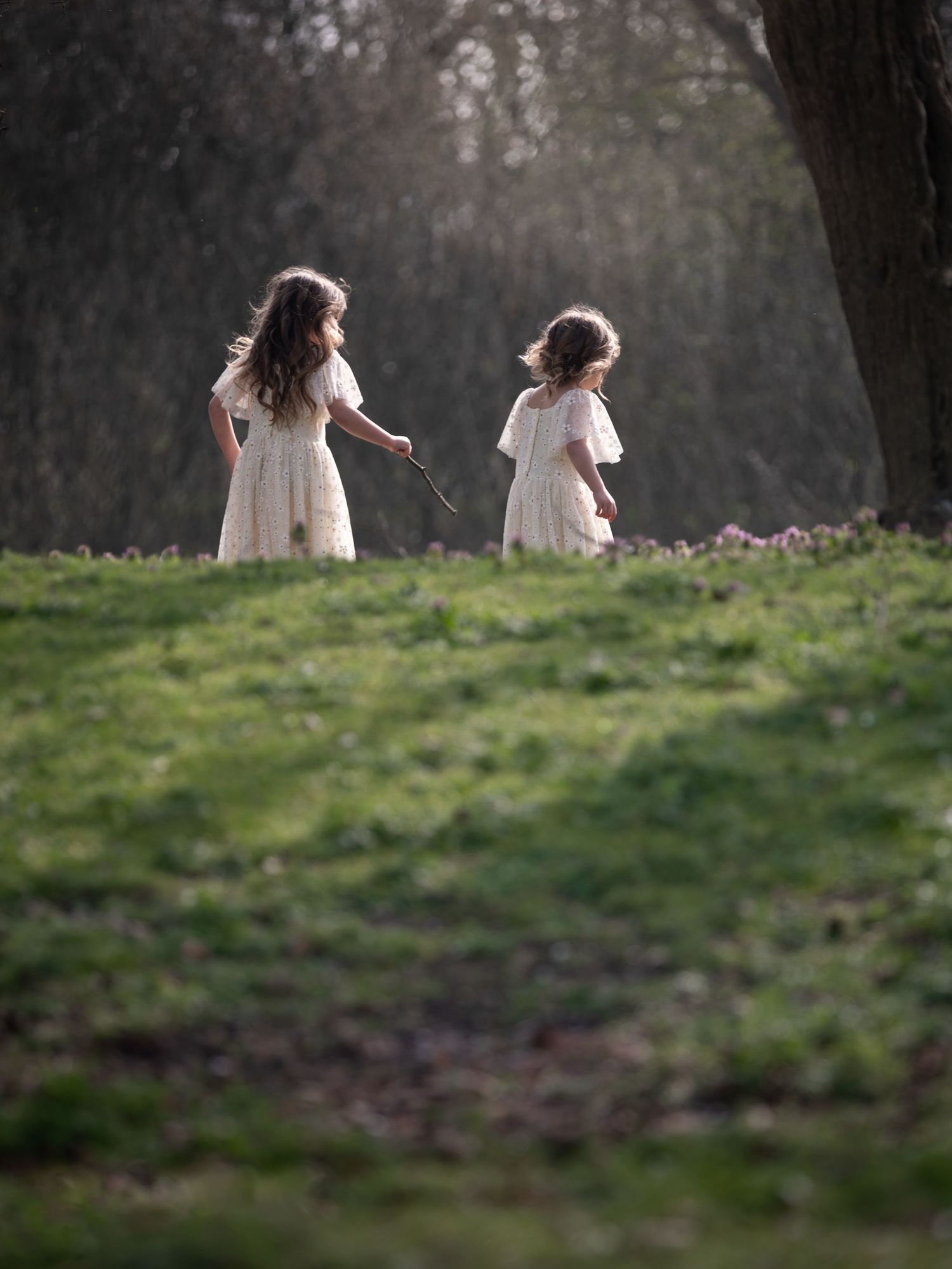 Two girls in white dresses walking on a grassy hill in soft golden light.

East Park Hull